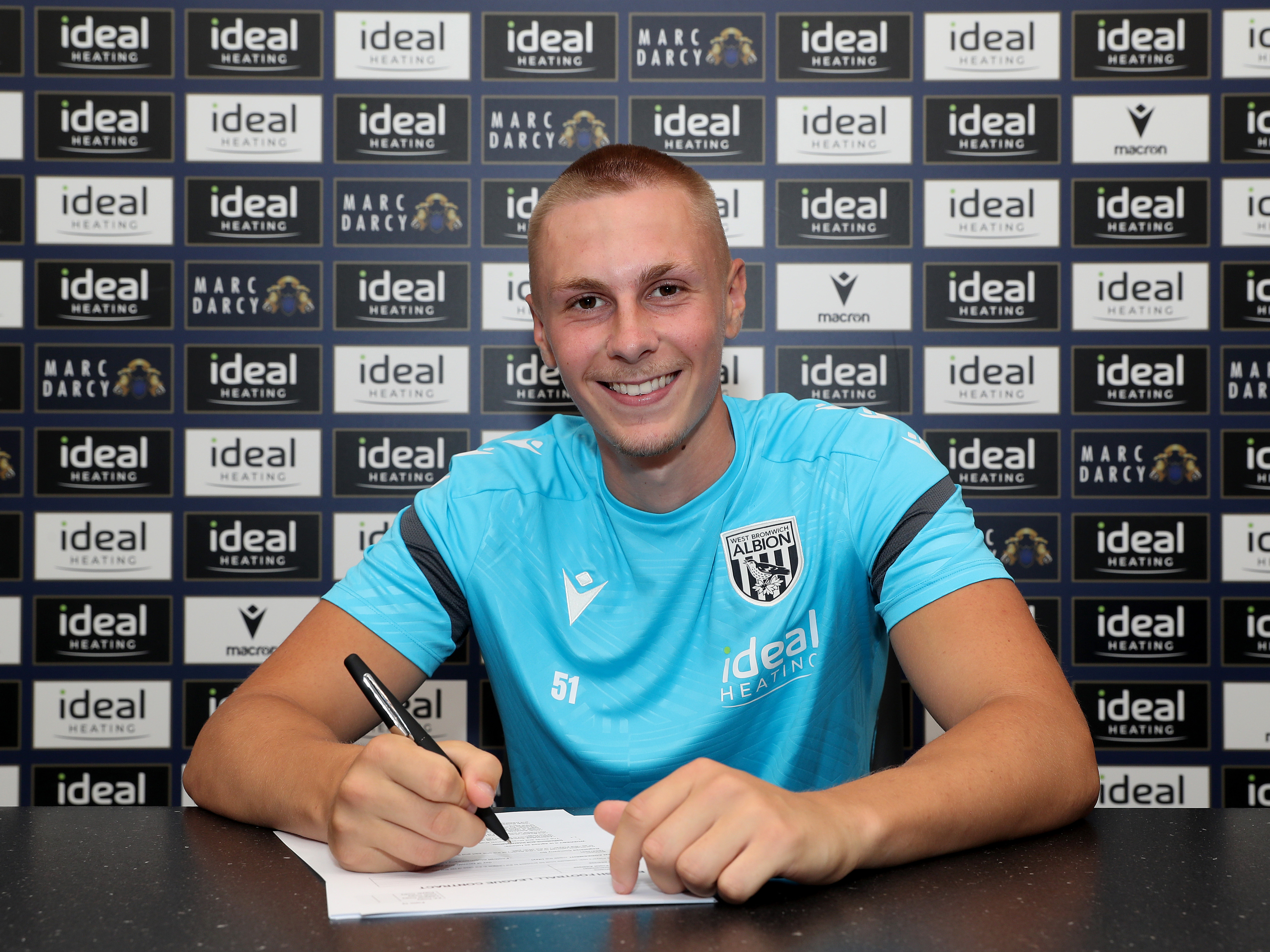 A photo of Albion forward Layton Love signing an extended contract with the club