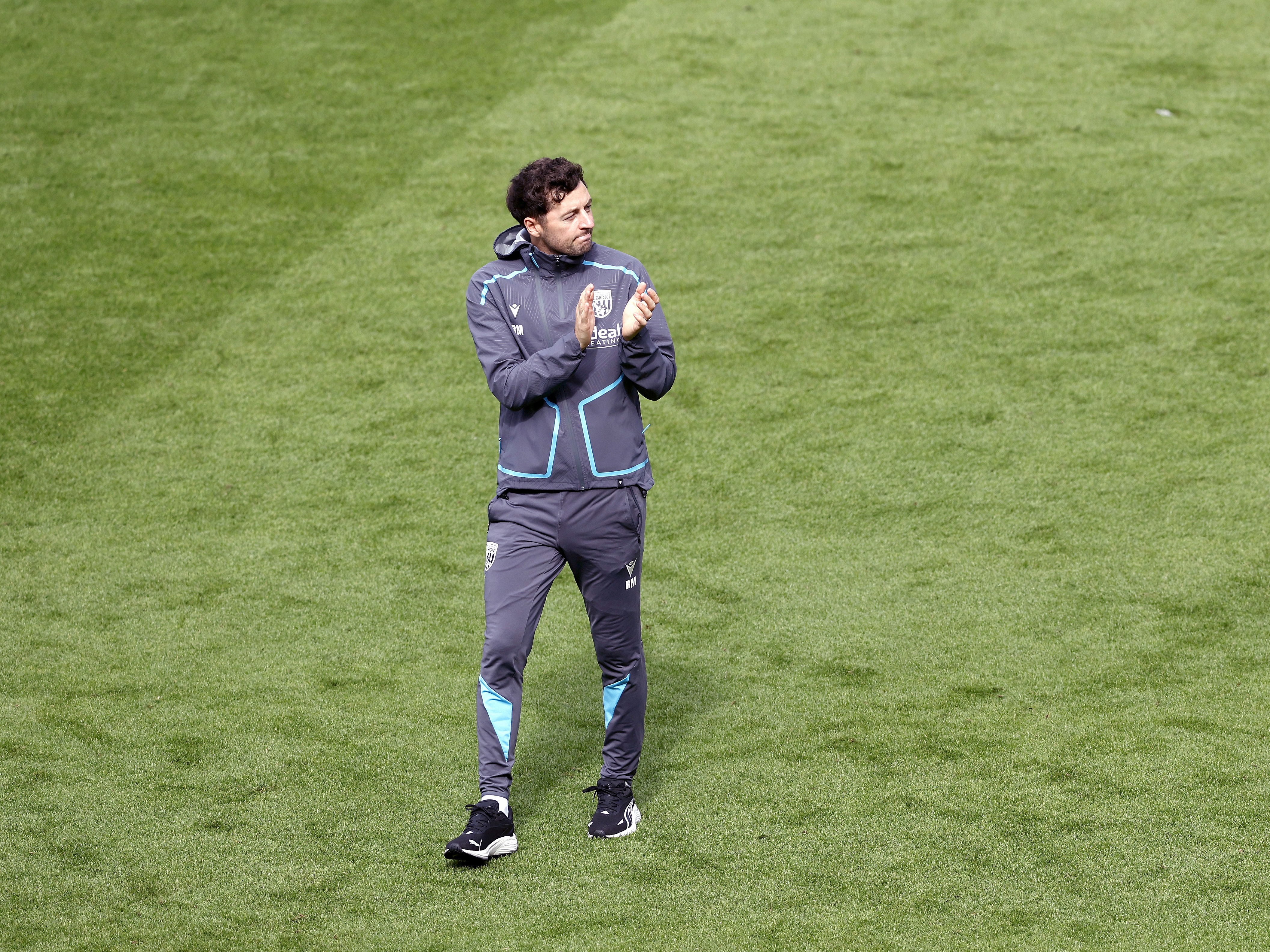An image of Ryan Mason applauding the fans at Blackpool