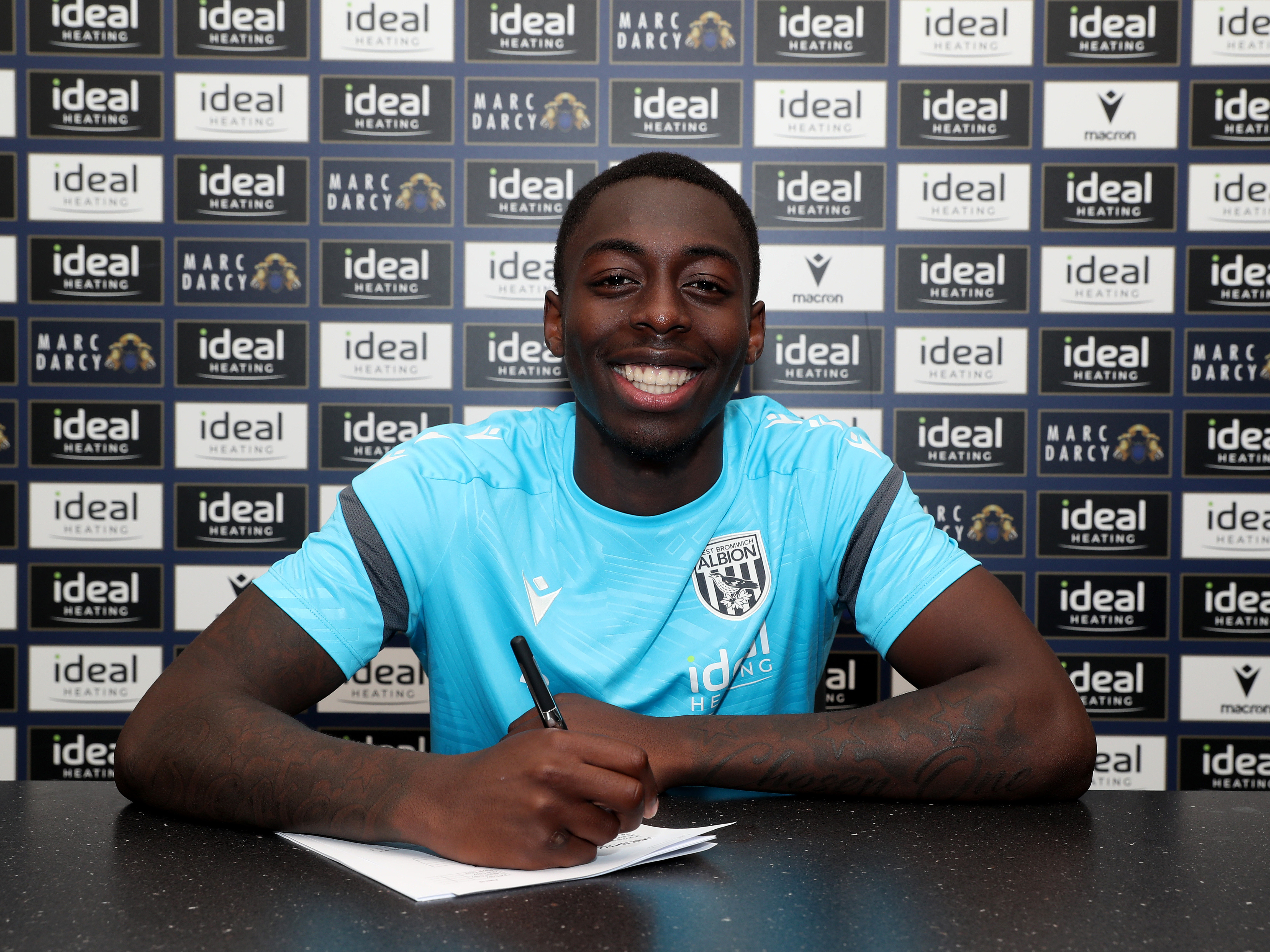 A photo of Albion U21 striker Eseosa Sule signing an extended contract 