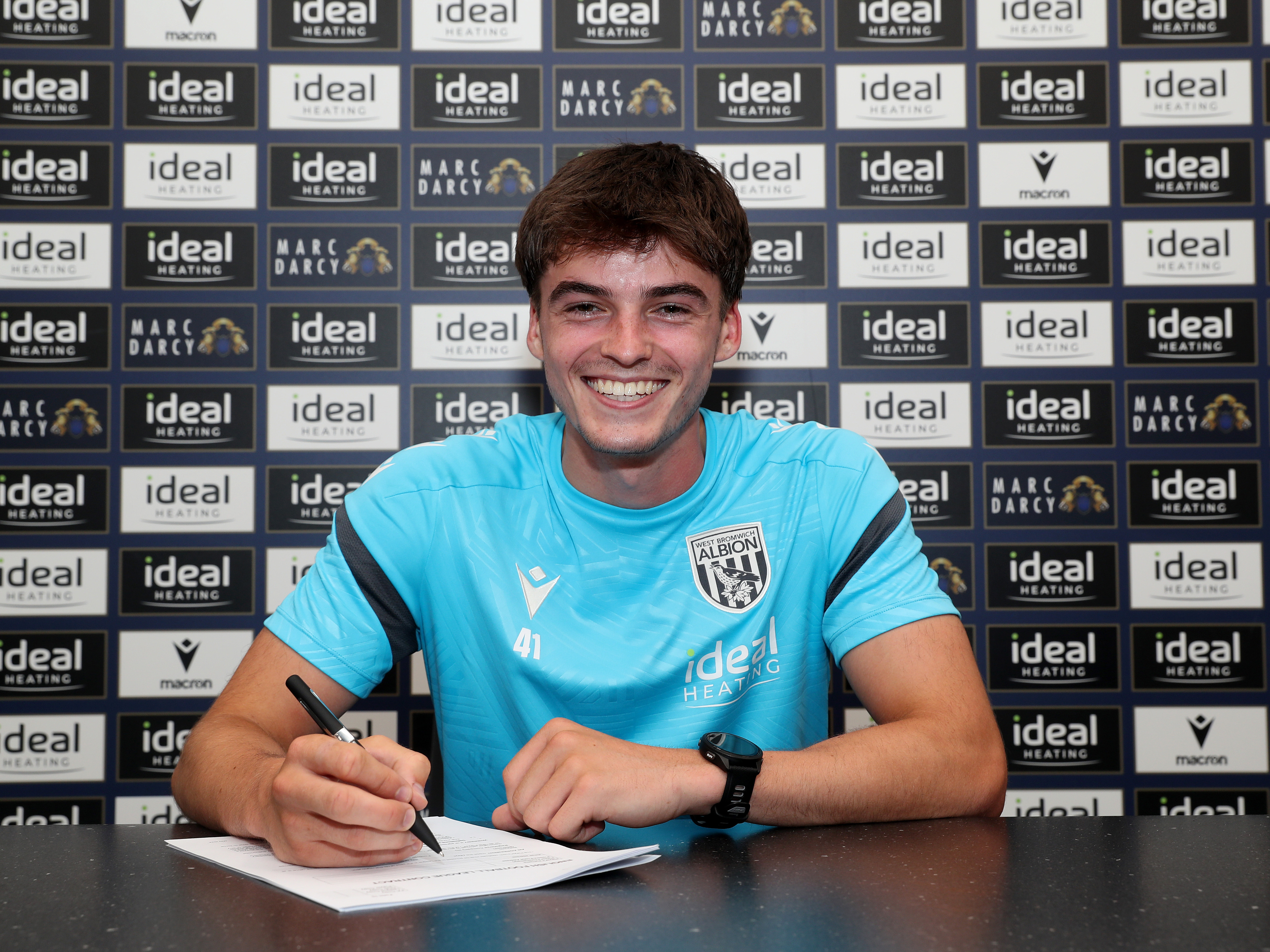 A photo of Albion defender Alex Williams signing an extended contract with the club