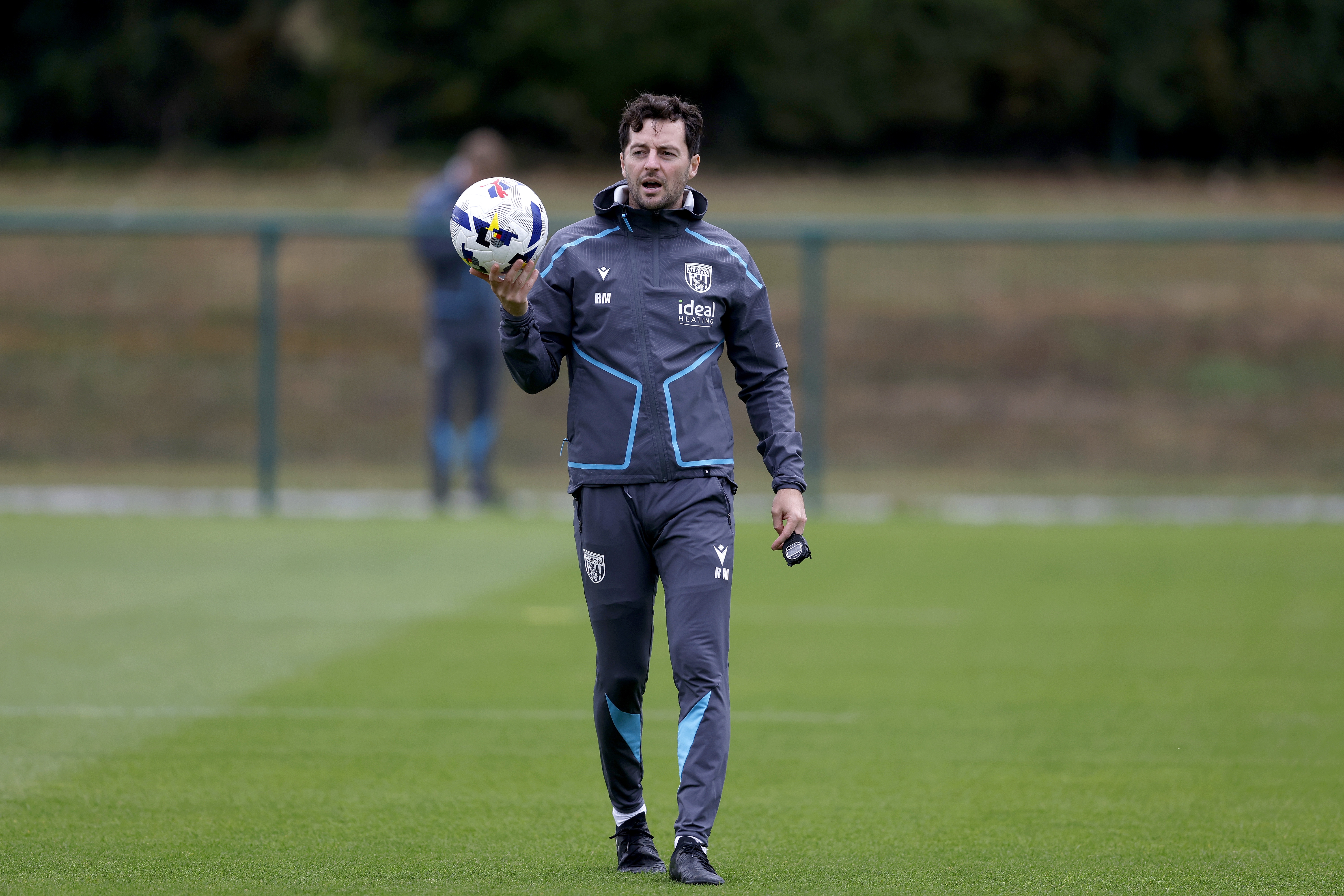 Ryan Mason holding a ball during a training session 