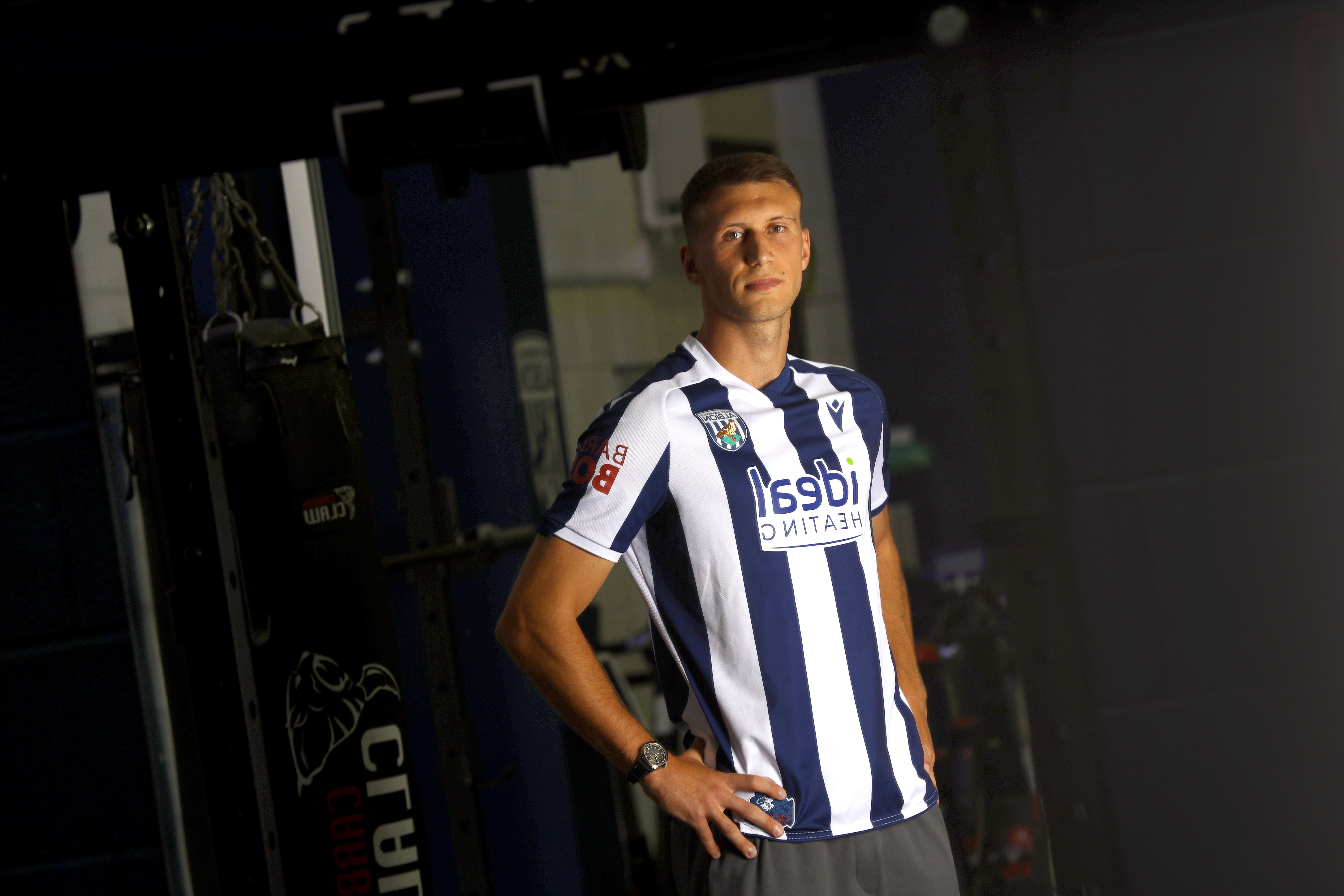 Krystian Bielik in a home shirt in the gym looking at the camera 