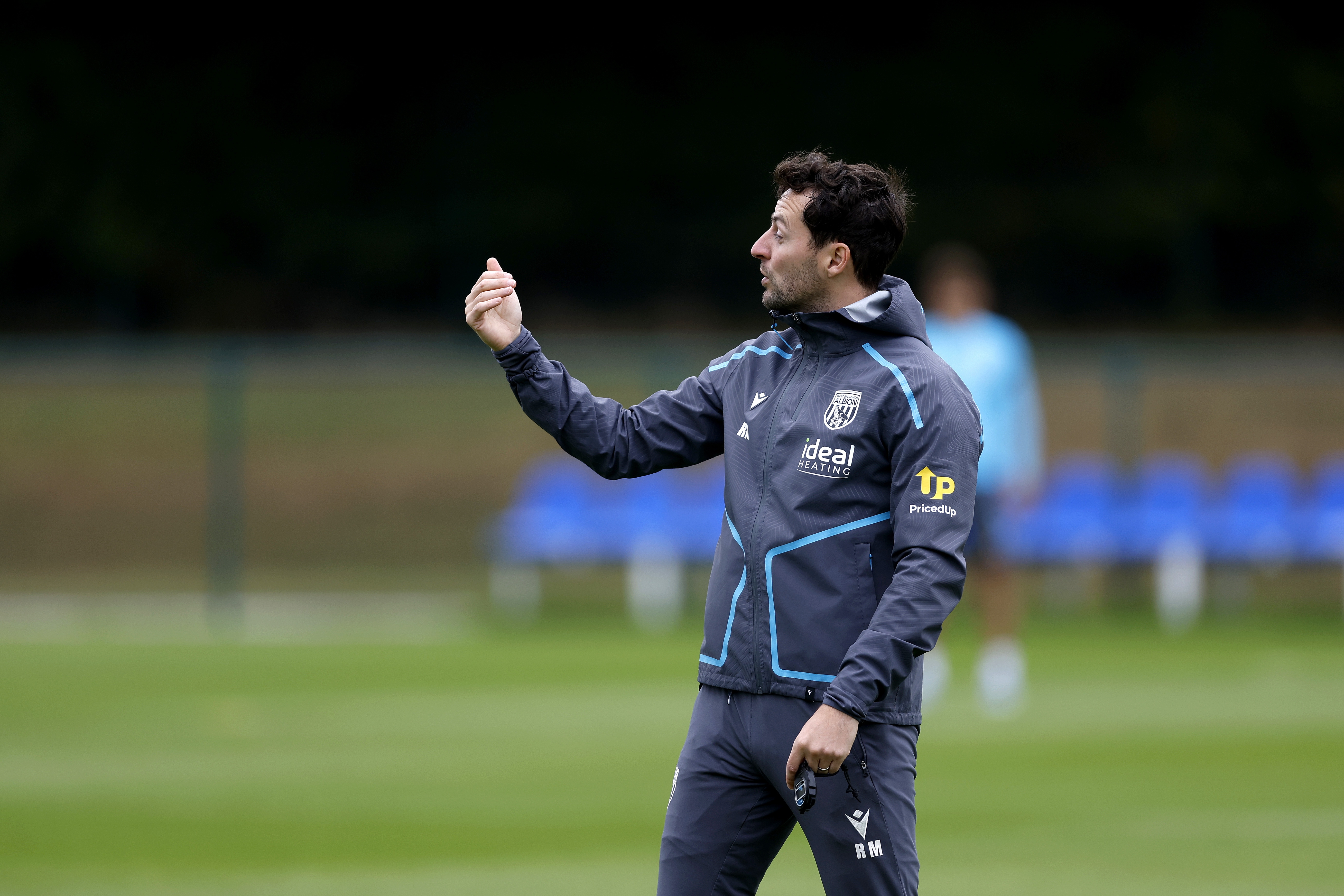 Ryan Mason delivering instructions to his players during a training session
