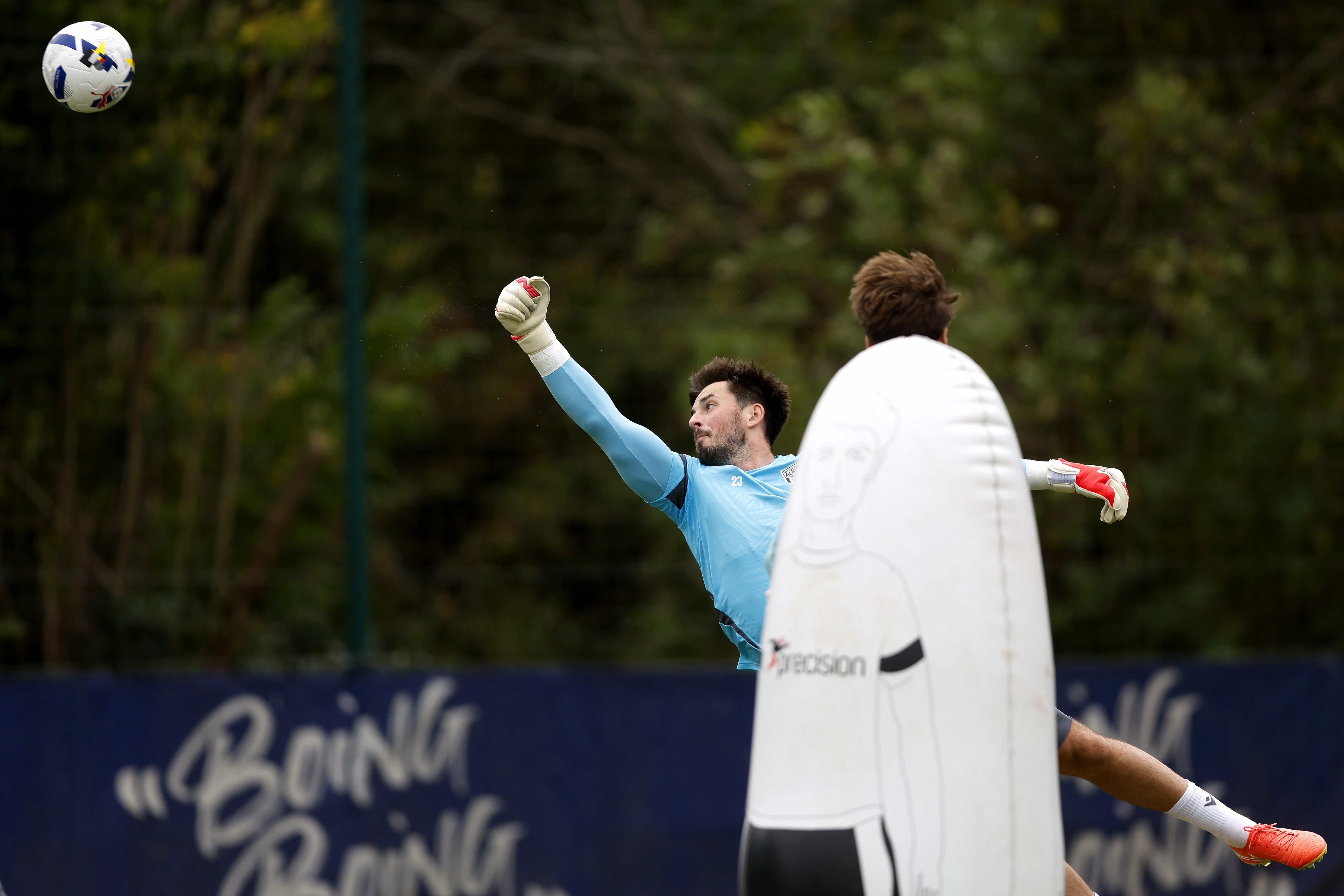 Joe Wildsmith punching a ball during a training session