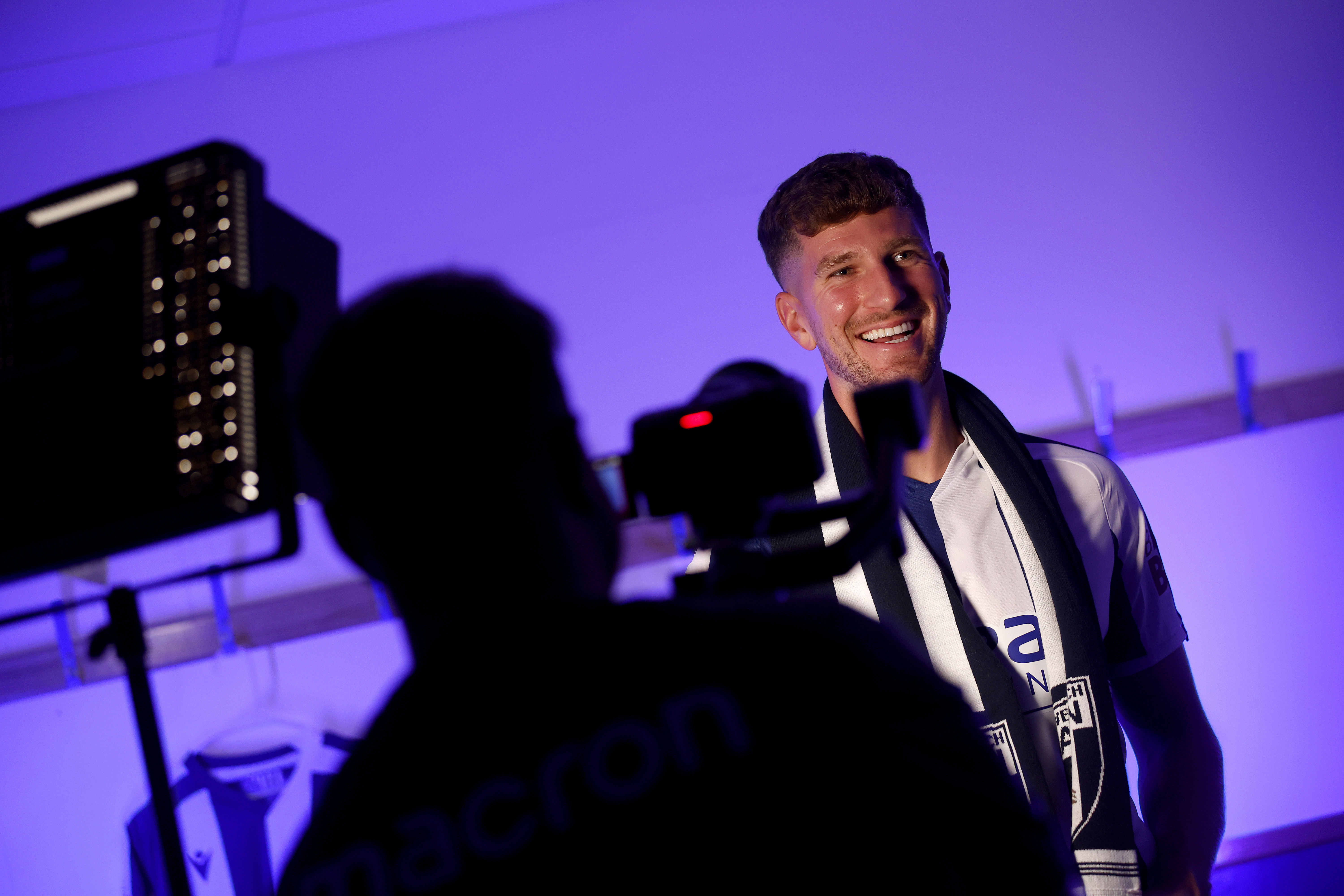 Chris Mepham smiling while being filmed by WBA TV