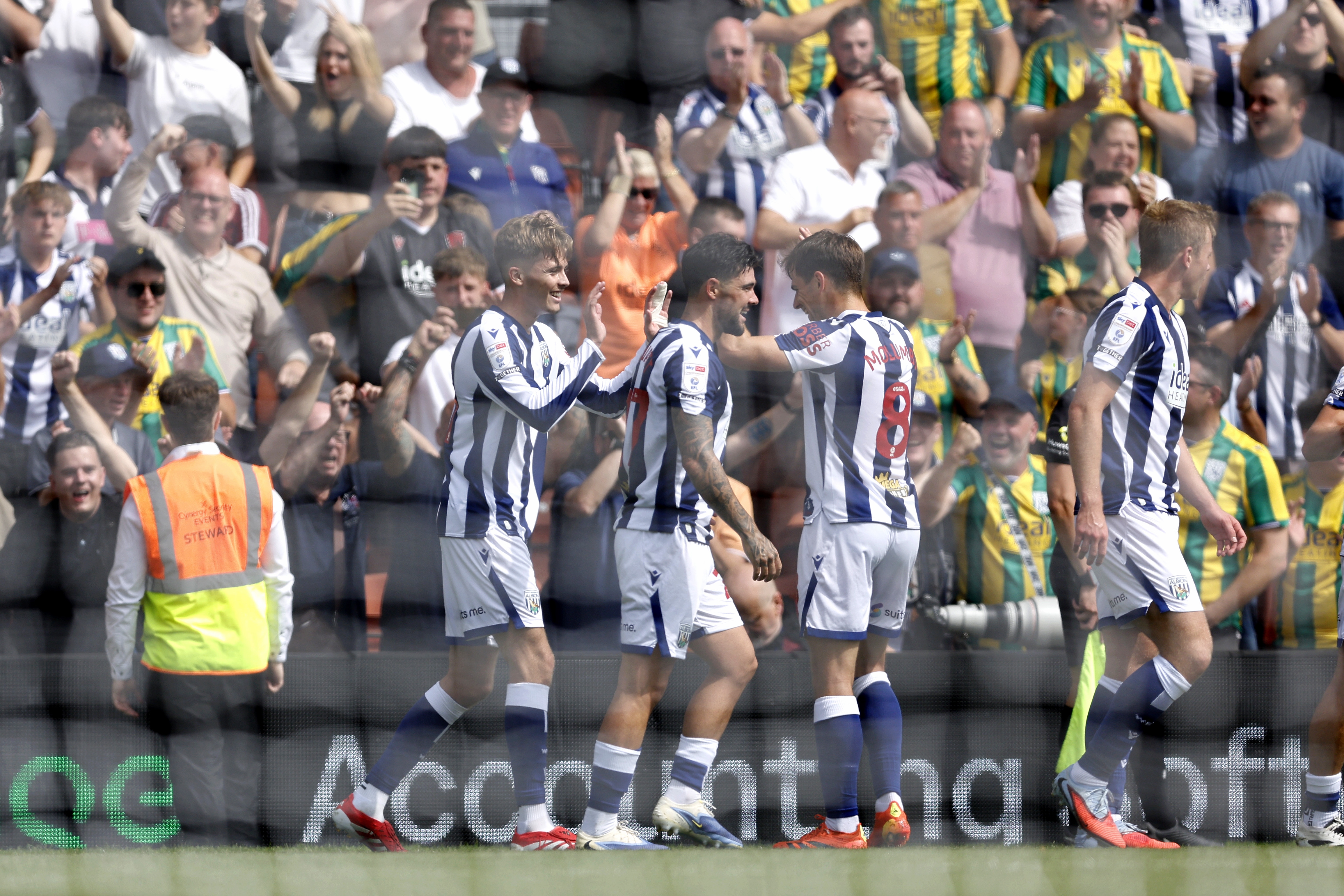 Isaac Price celebrates scoring his first goal at Wrexham with team-mates