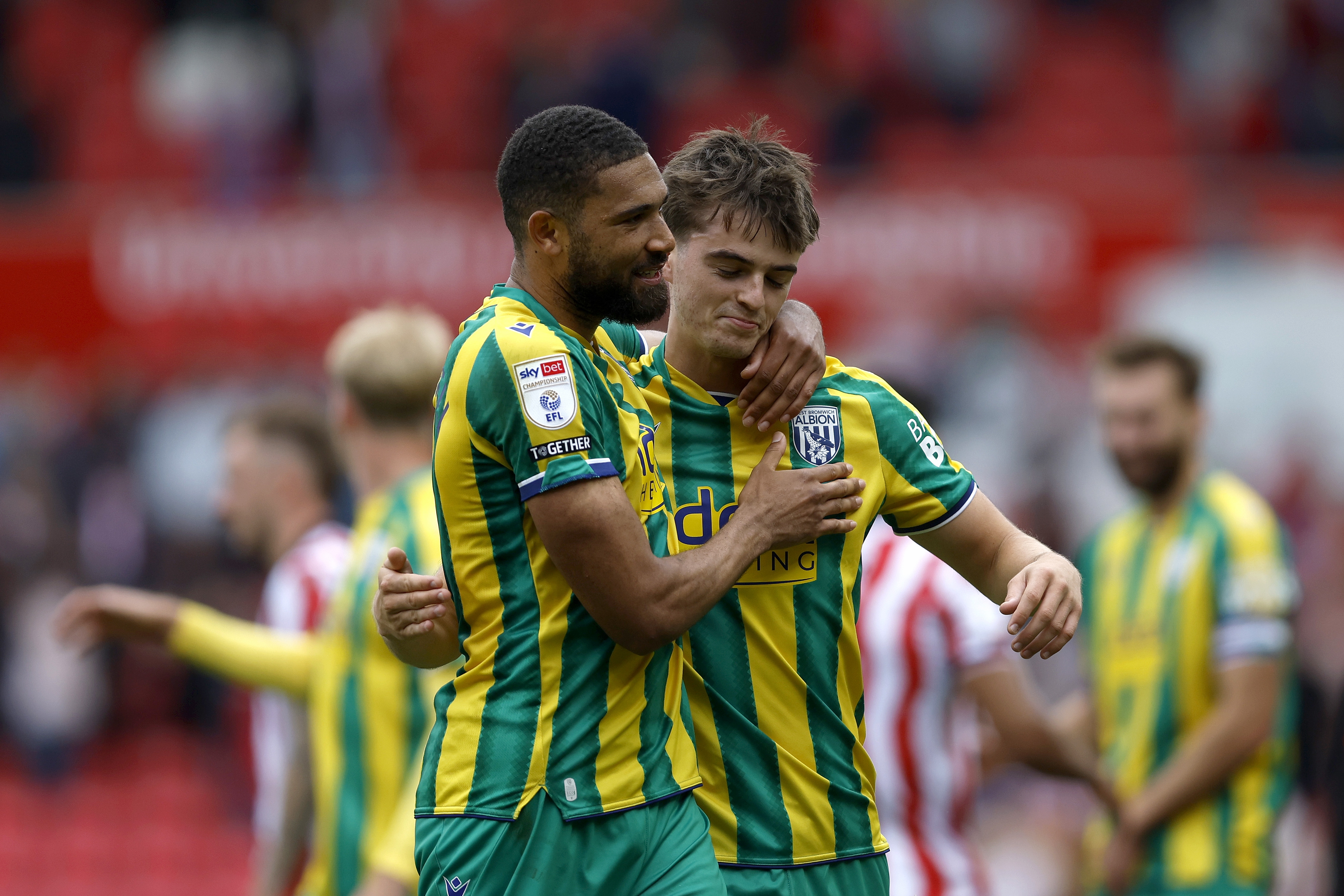 George Campbell and Alex Williams embrace after Albion's win at Stoke