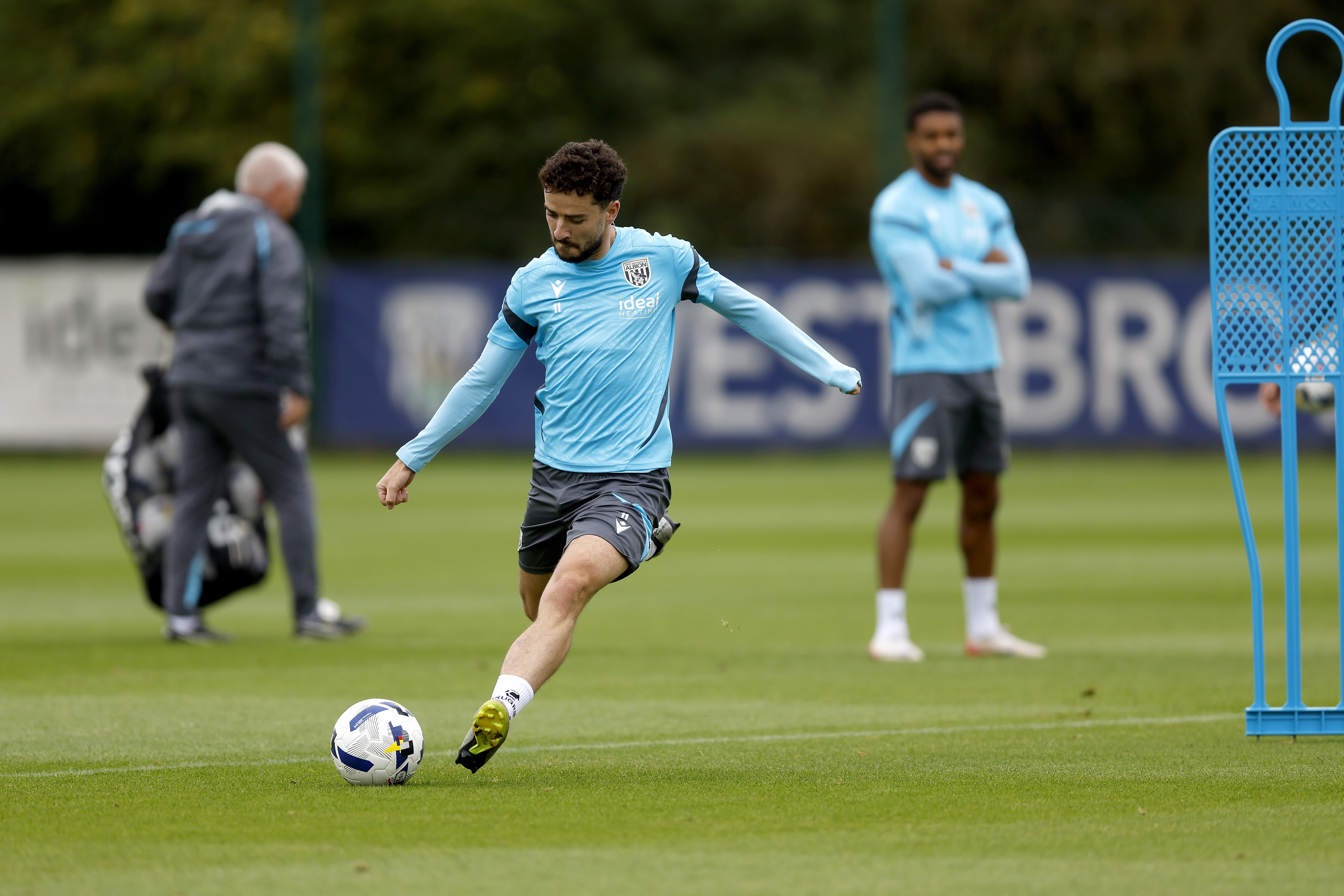 Mikey Johnston striking the ball during training 
