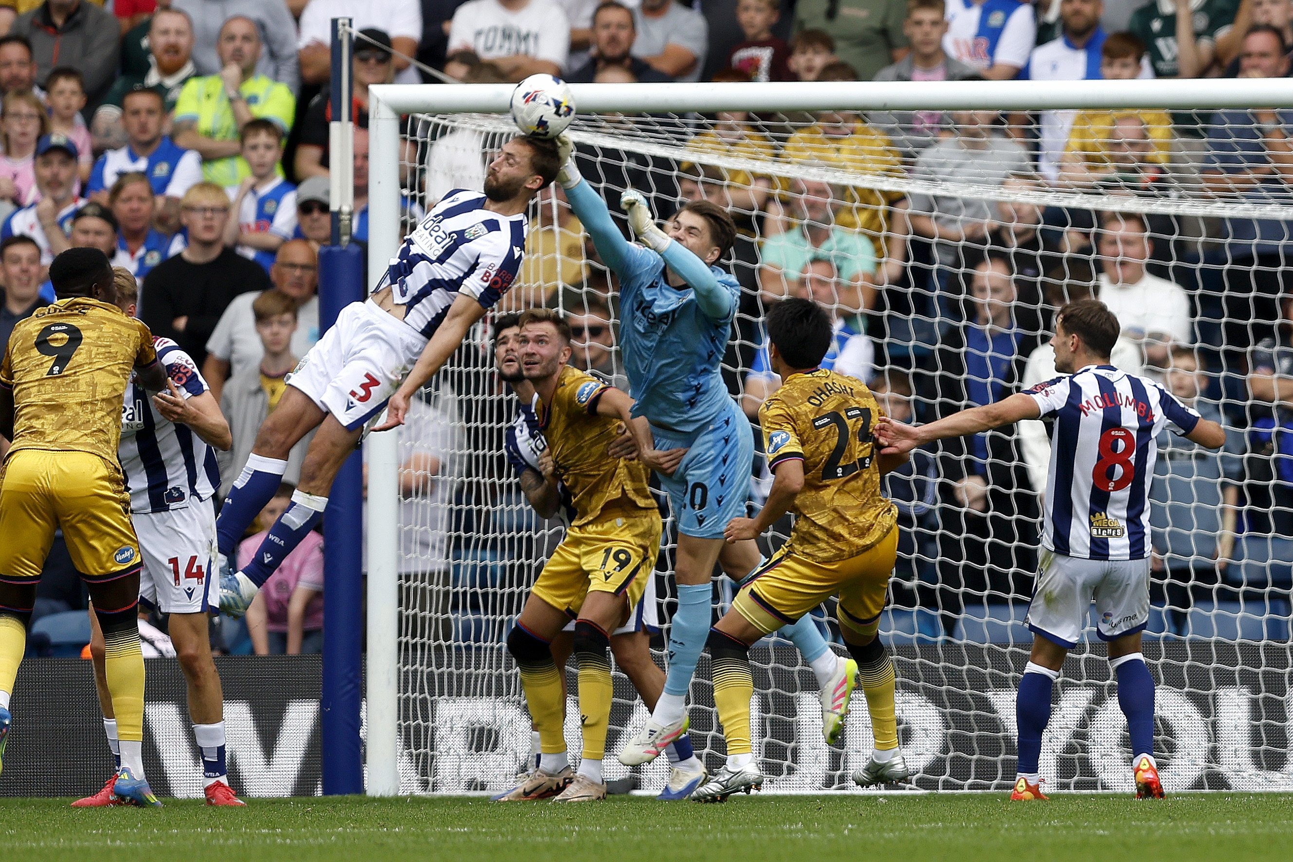 Nat Phillips trying to head the ball and Josh Griffiths trying to punch it away against Blackburn