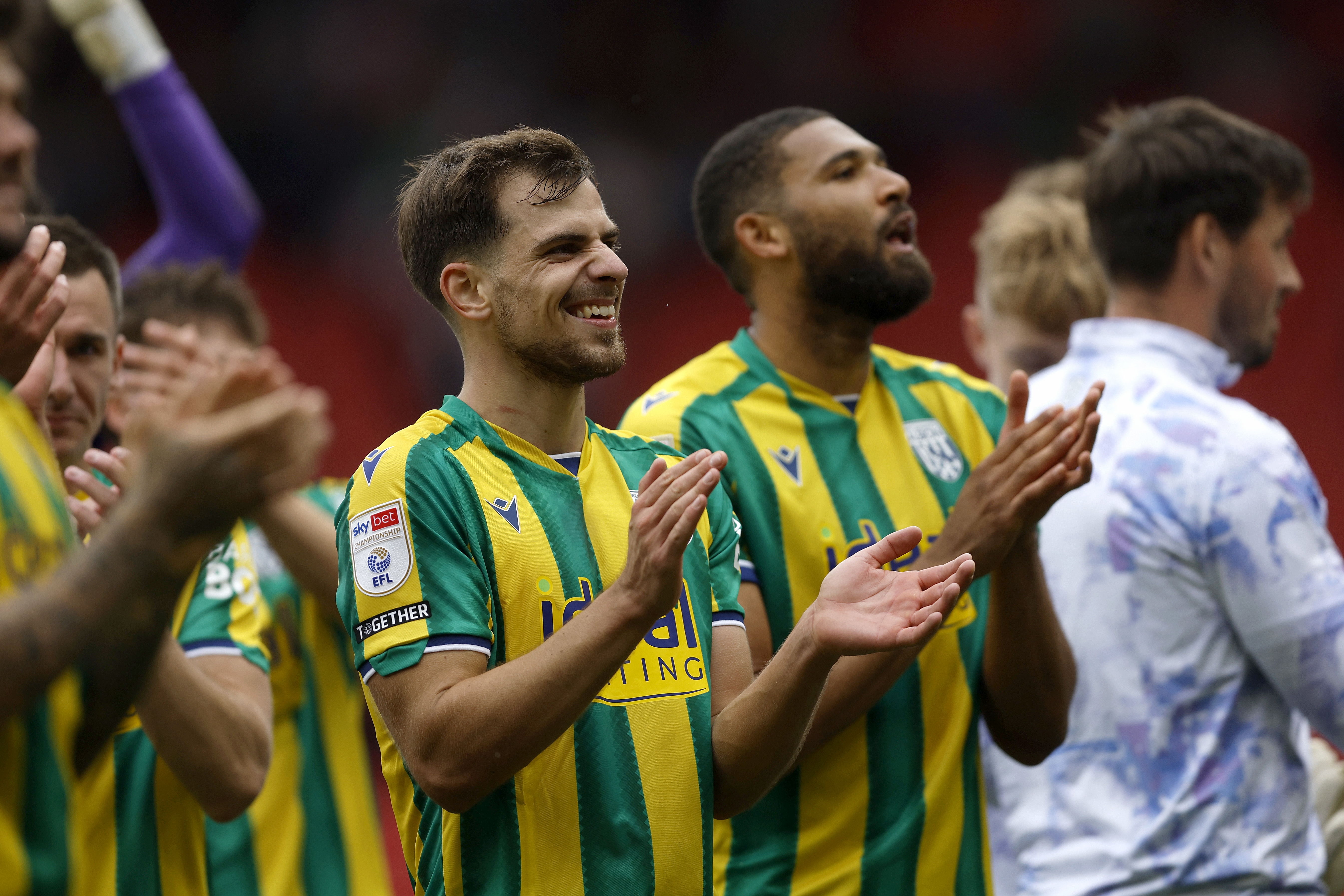 Jayson Molumby and George Campbell applauding WBA fans at Stoke