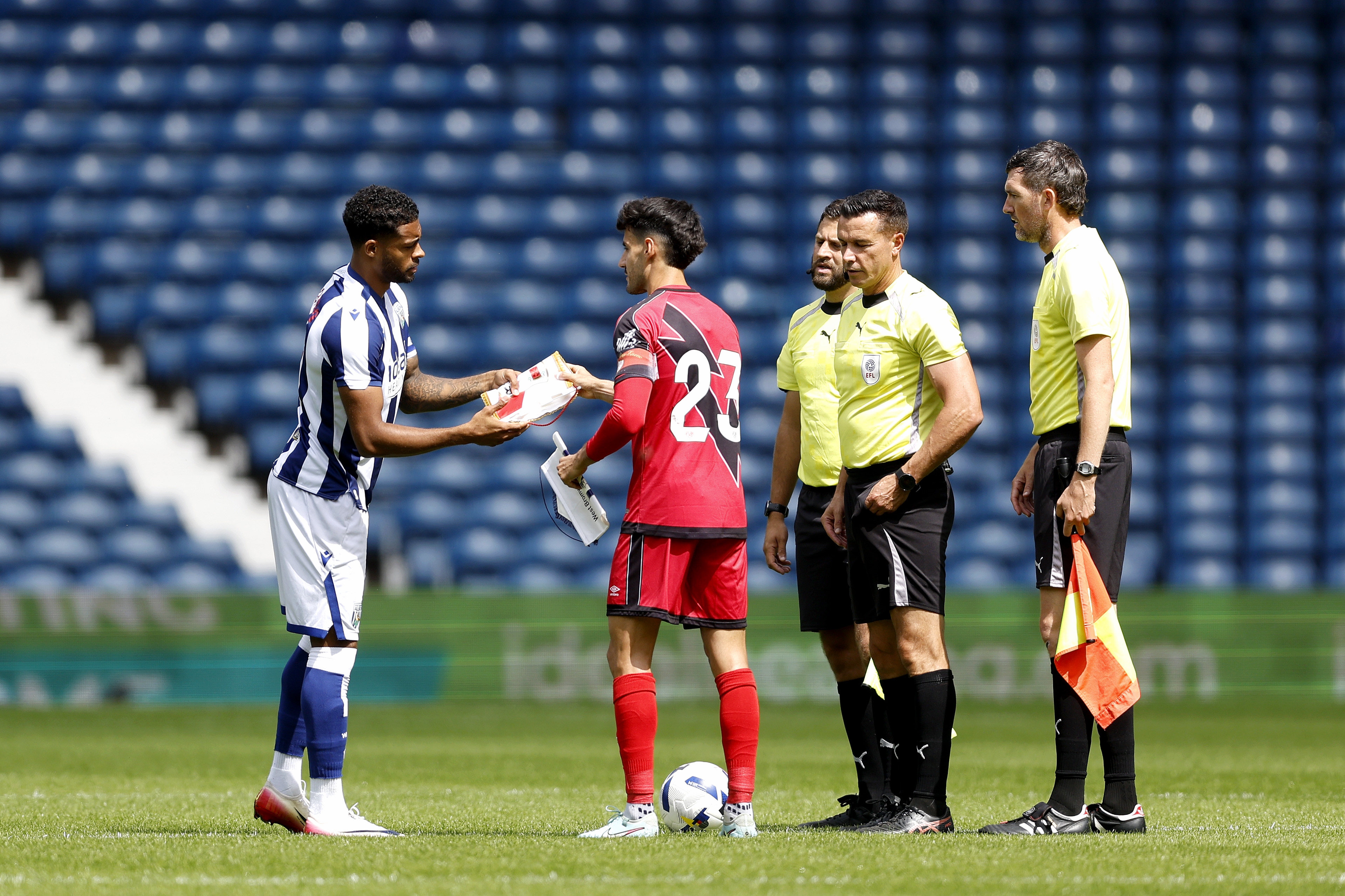 Darnell Furlong and Rayo Vallecano's captain shake hands and swap gifts before kick-off in the centre circle