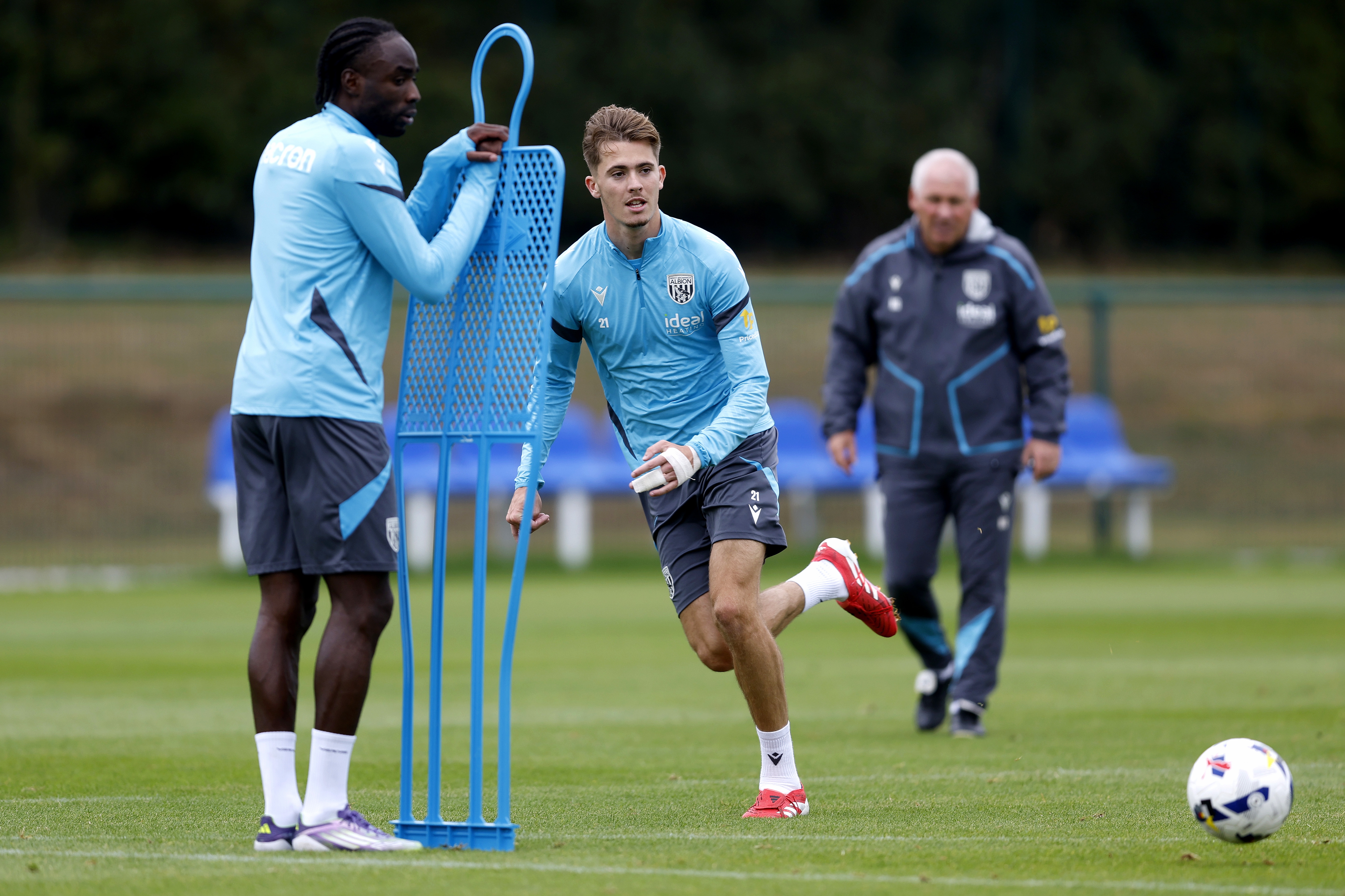 Isaac Price running past a mannequin during training 