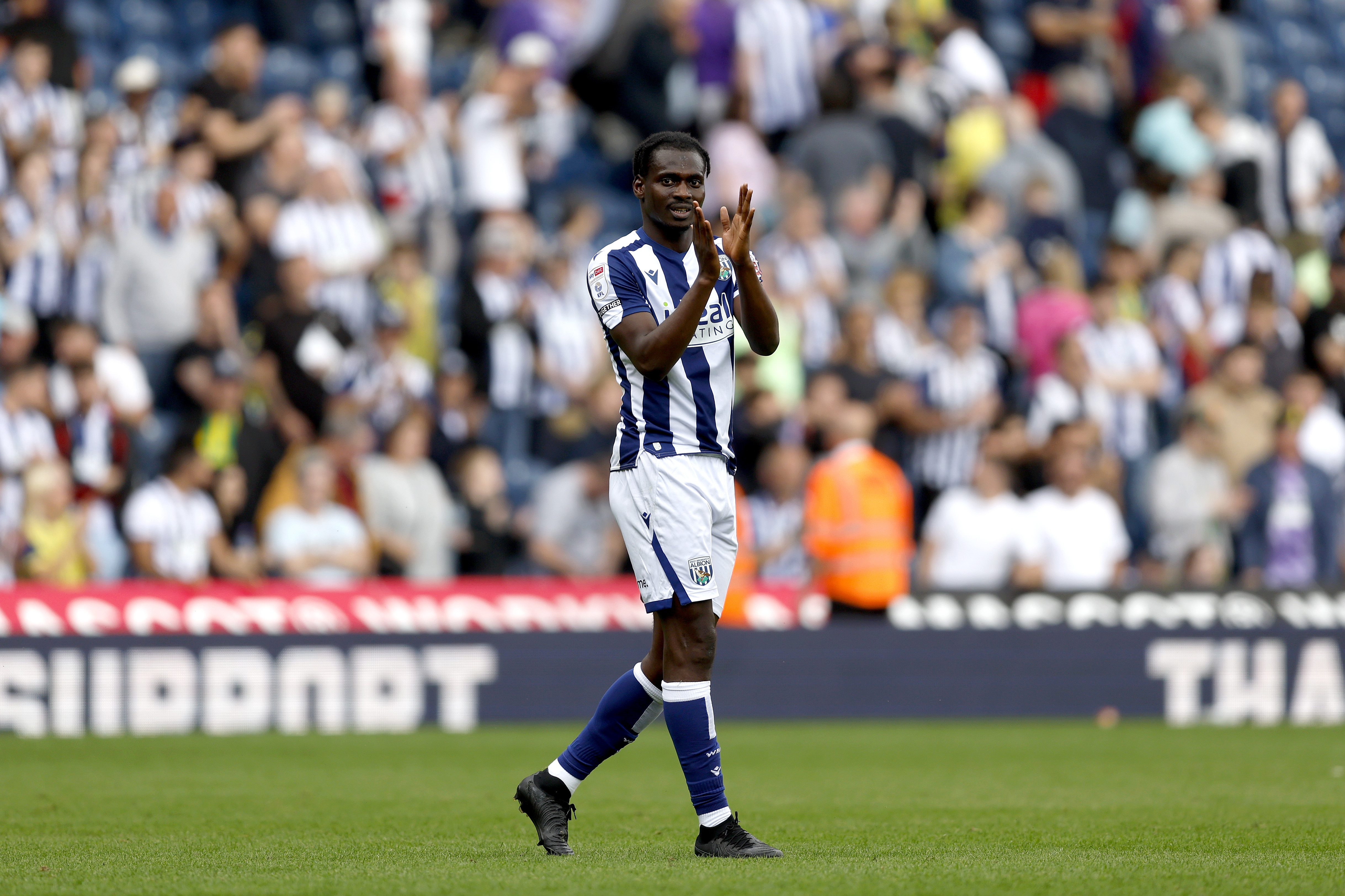 Ousmane Diakité applauding WBA fans after the win over Blackburn