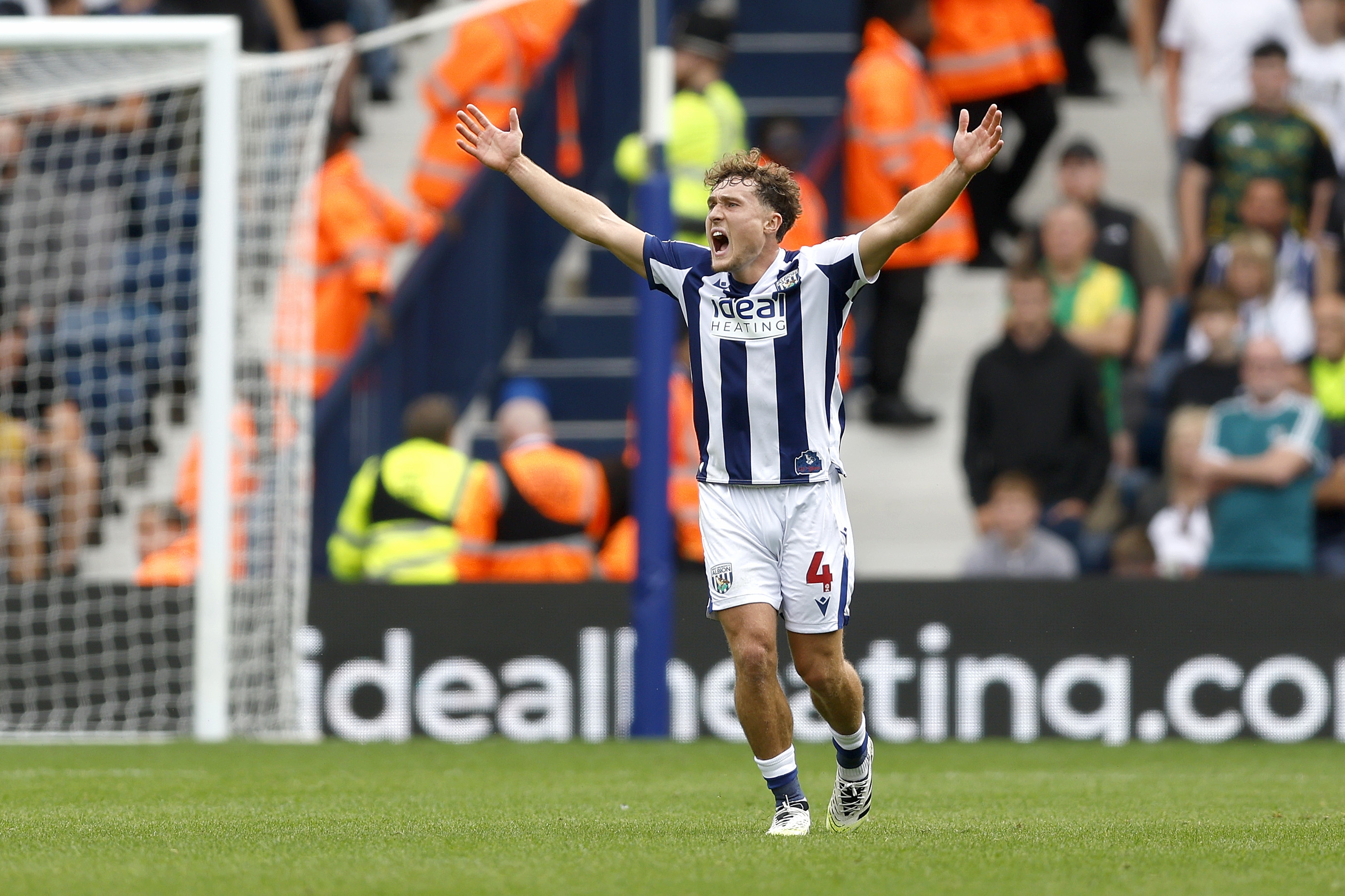 Callum Styles with his arms up against Blackburn