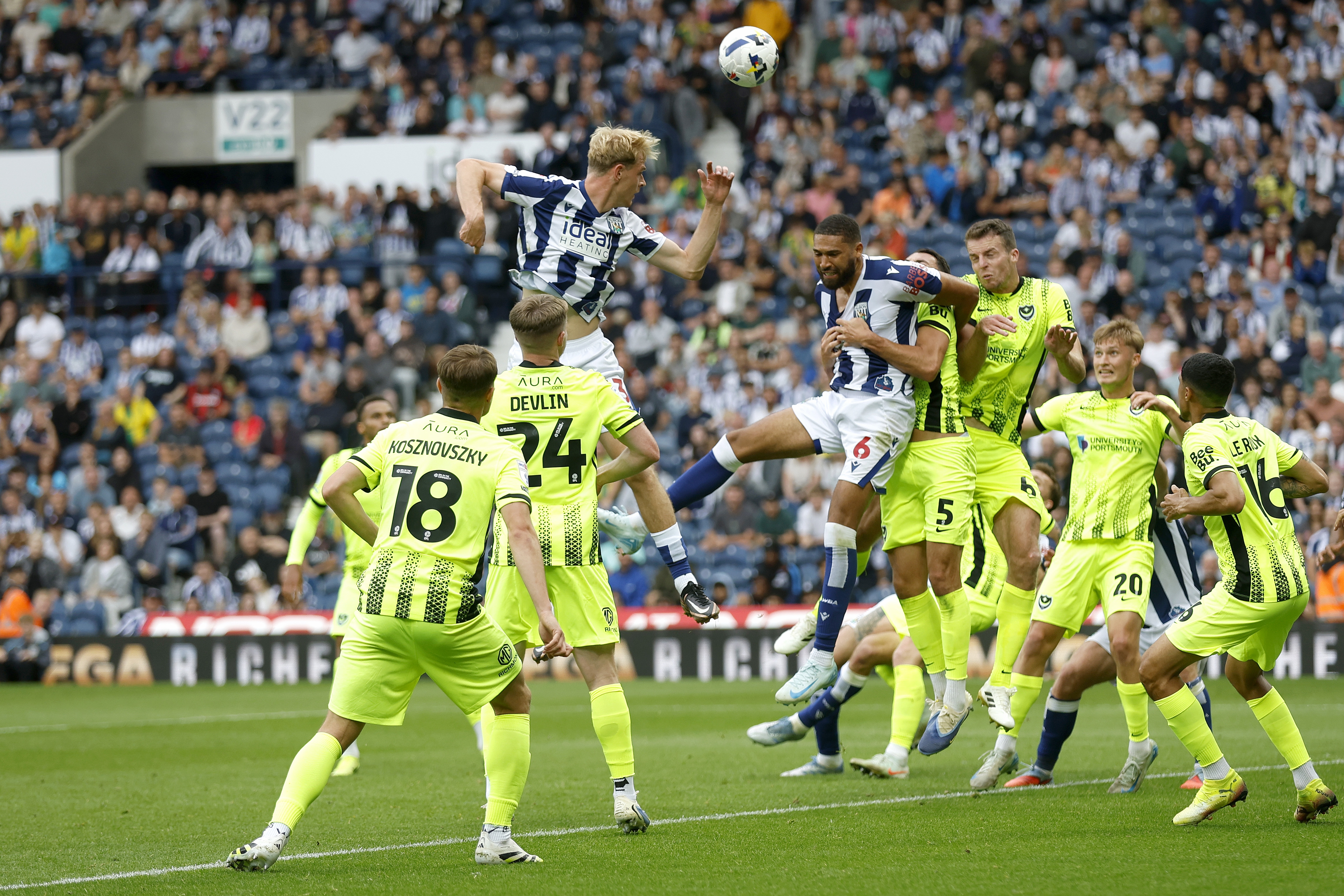 Albion players and Portsmouth players battle for the ball
