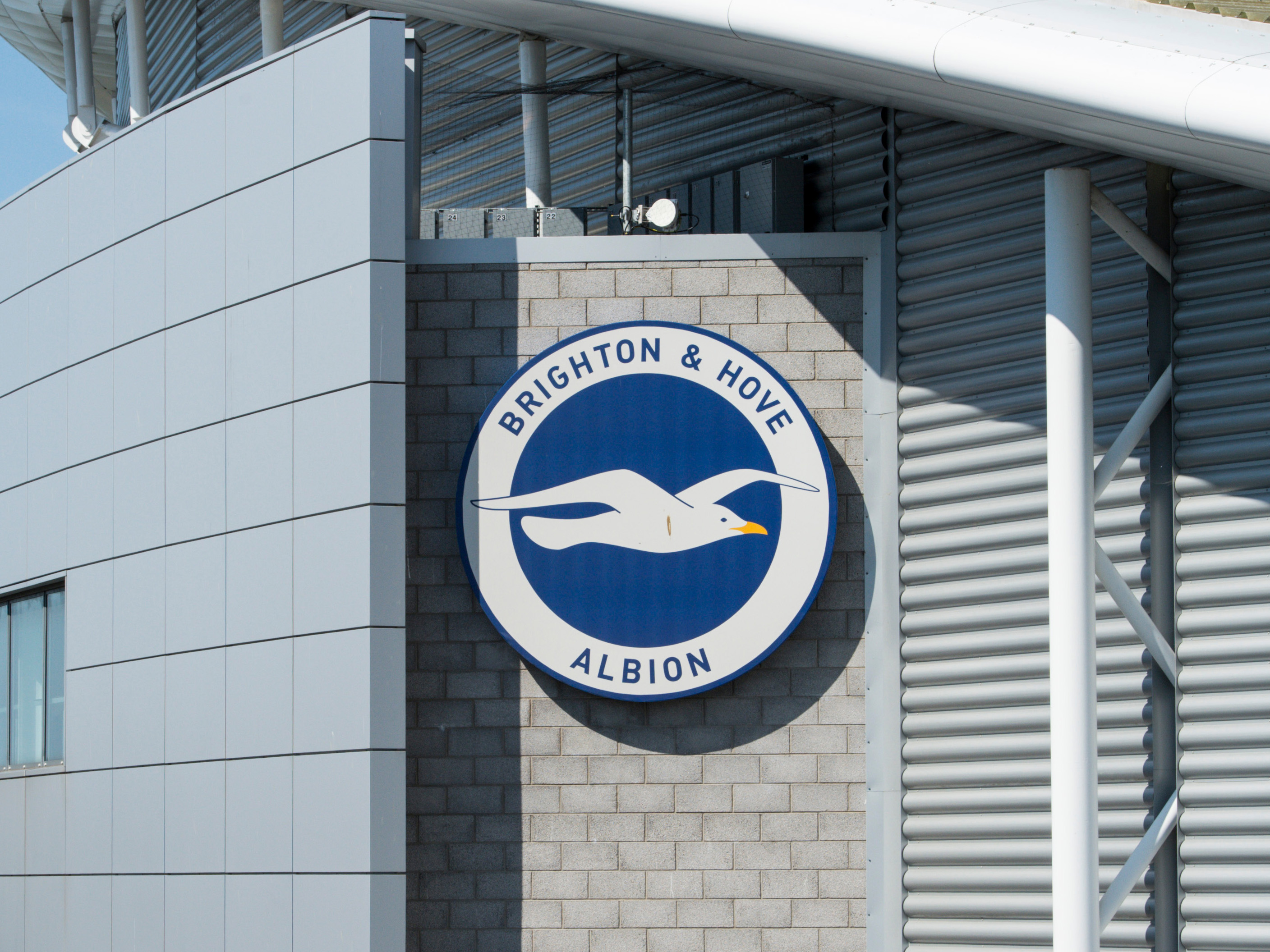 A photo of the Brighton FC badge on the outside of their home stadium