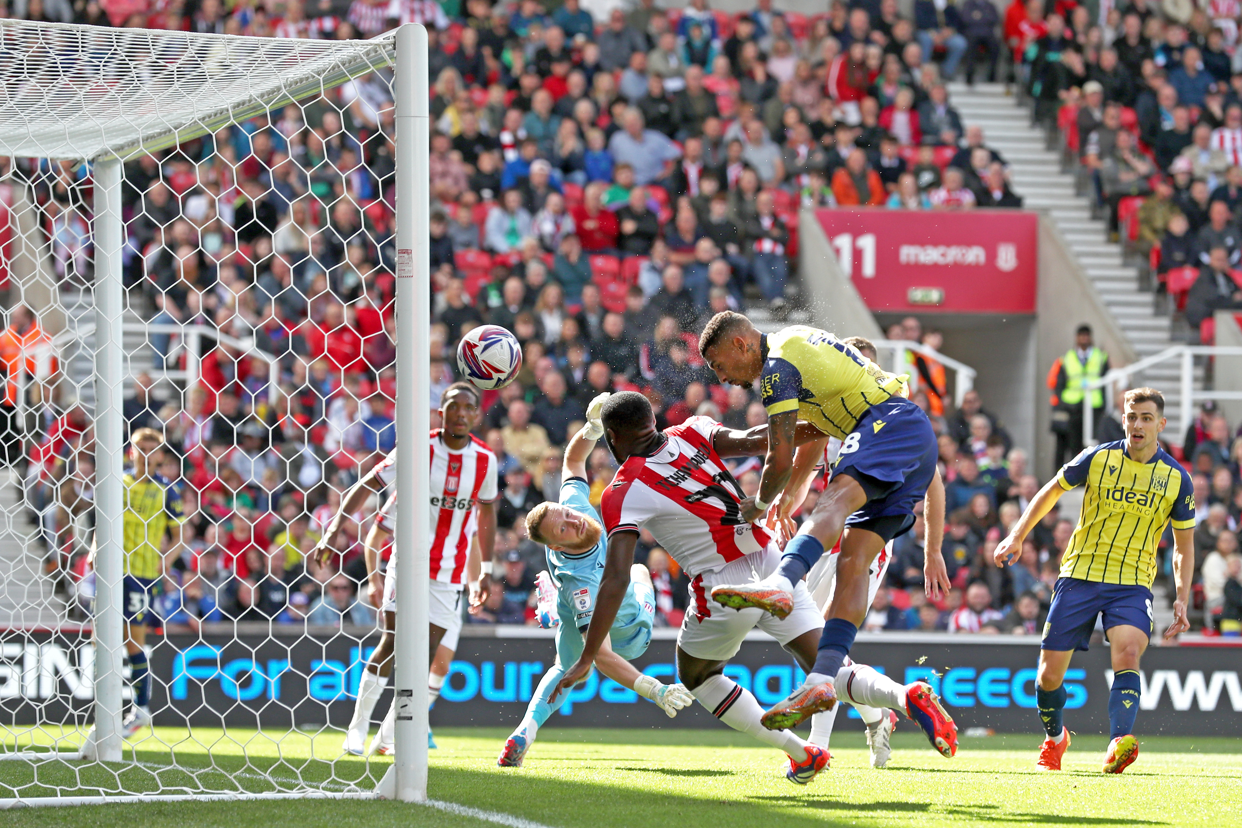 Karlan Grant scoring against Stoke City in the yellow away kit in August 2024