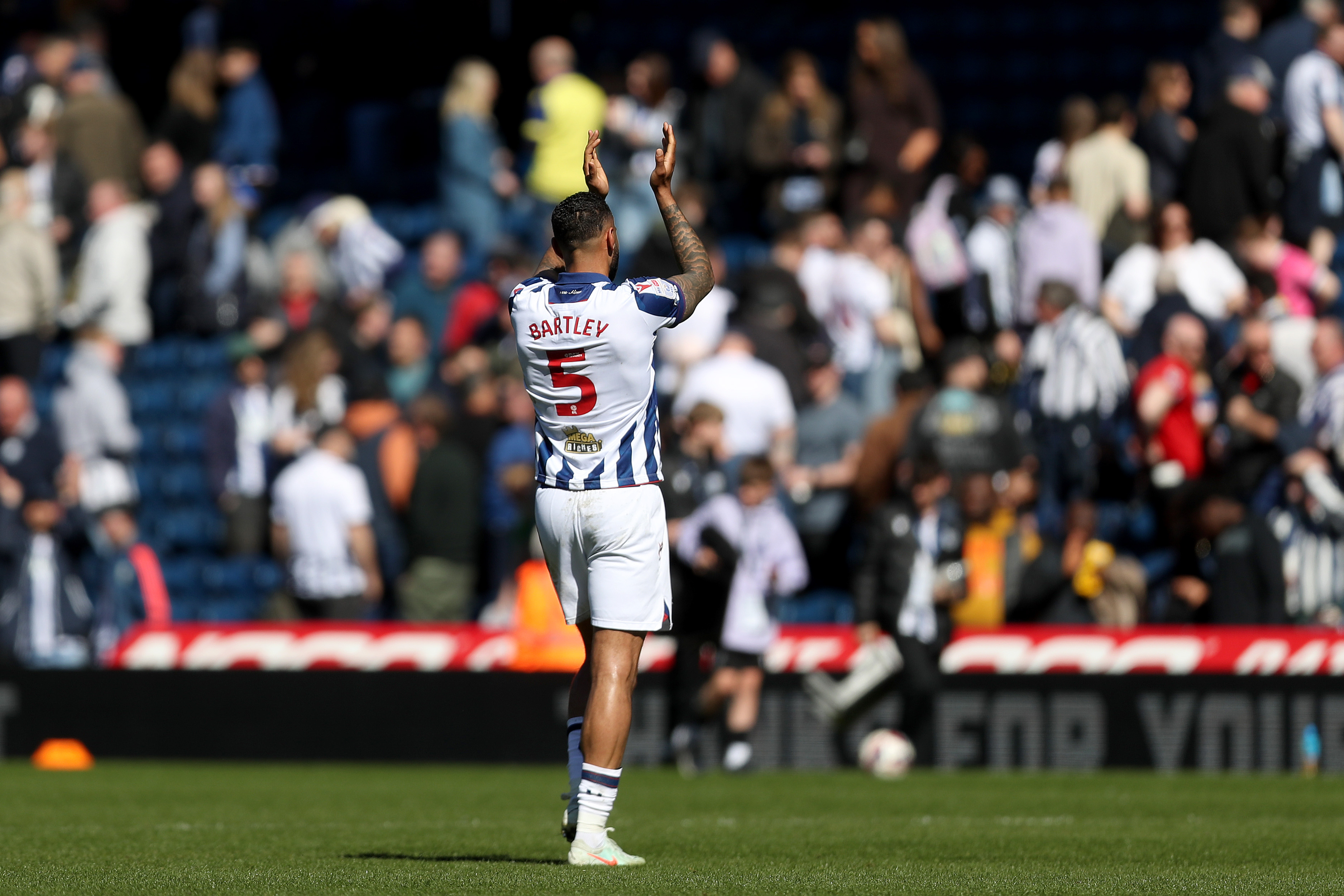 Kyle Bartley clapping WBA fans while wearing a home shirt 