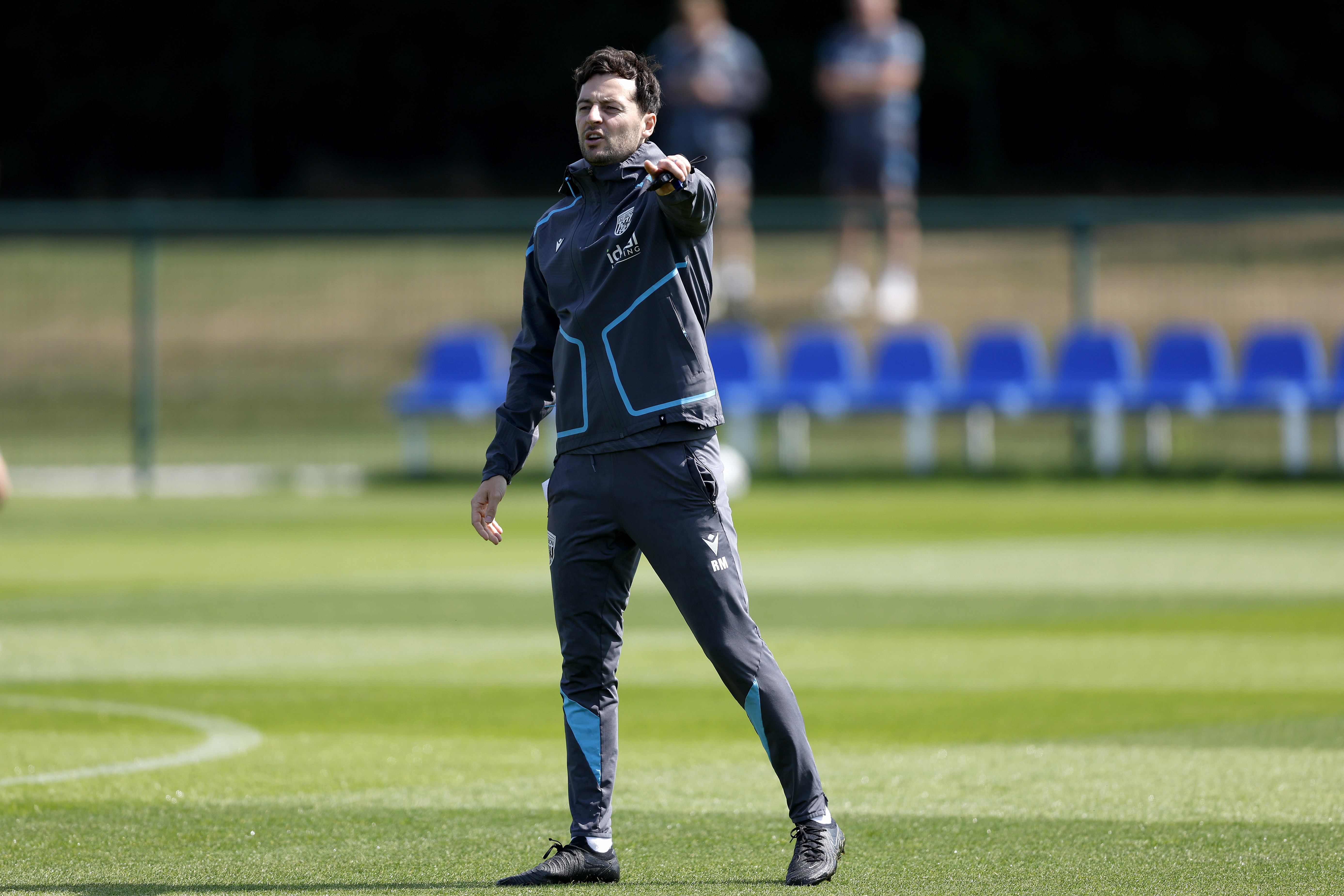 Ryan Mason delivering instructions to players on the training pitch
