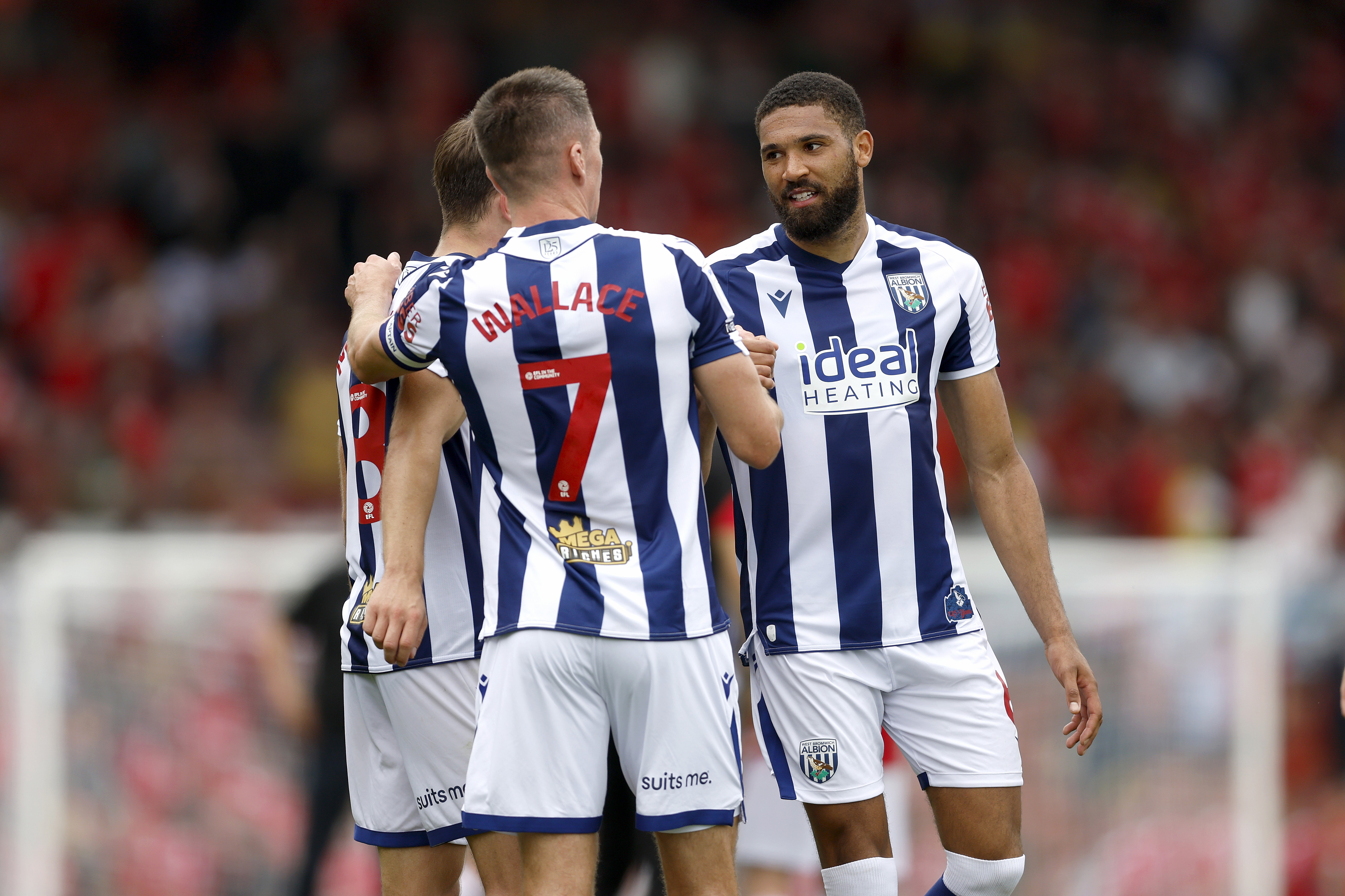 George Campbell talking to Jed Wallace while in the home kit during a game