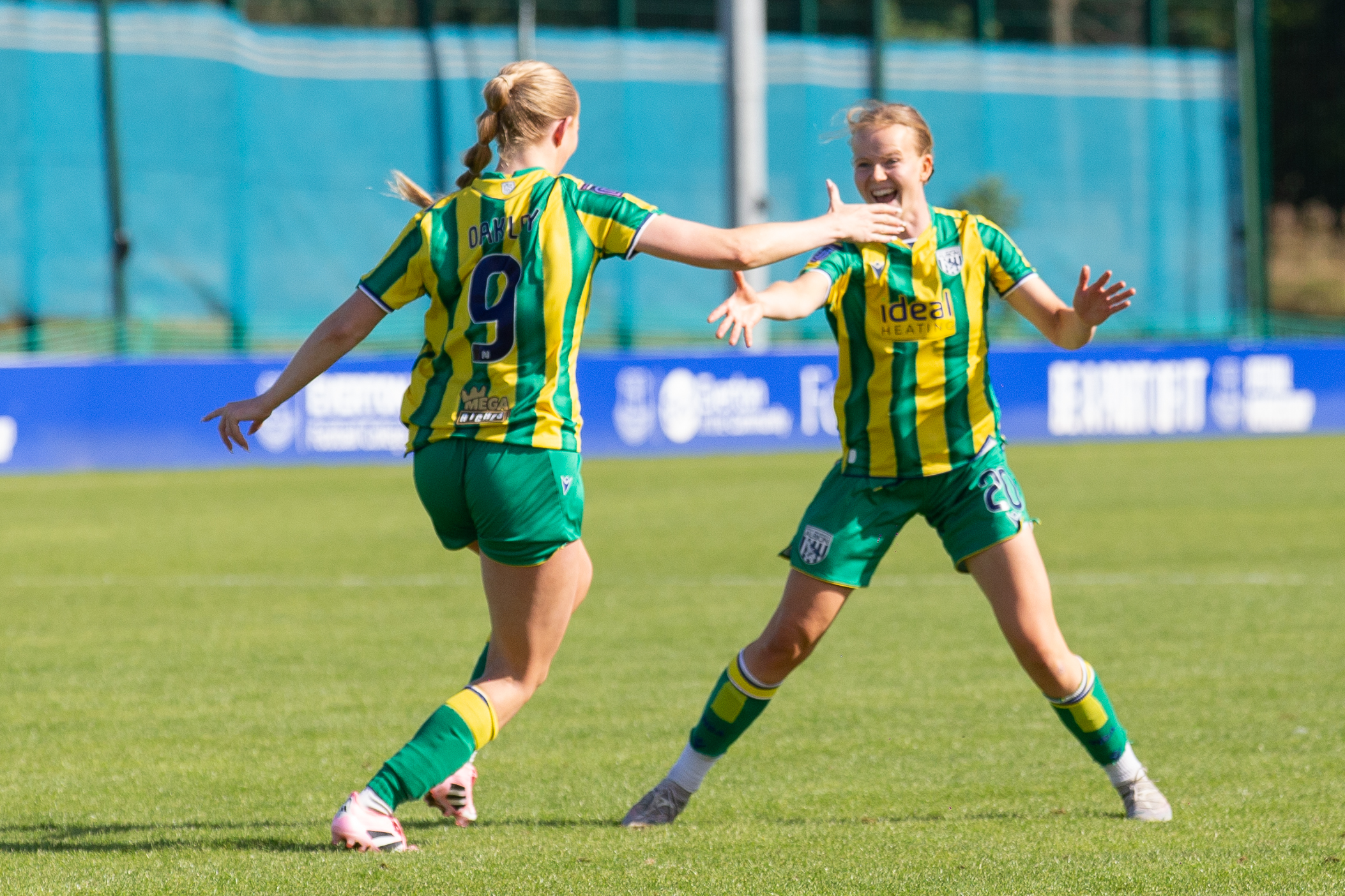 Rhianne Oakley high-fives Phoebe Warner.