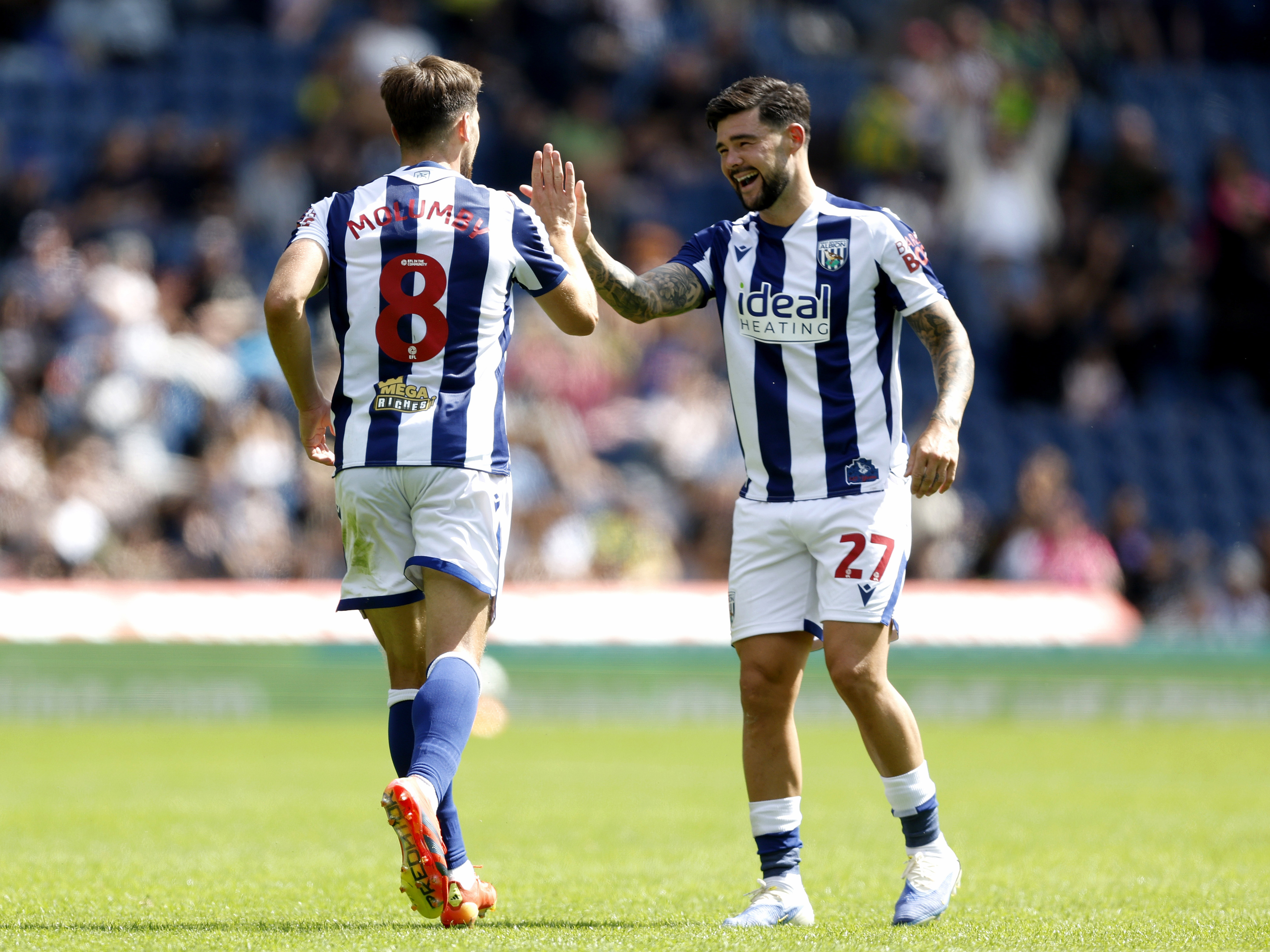 A photo of Albion midfielder Jayson Molumby celebrating with Alex Mowatt in the 2025/26 home kit