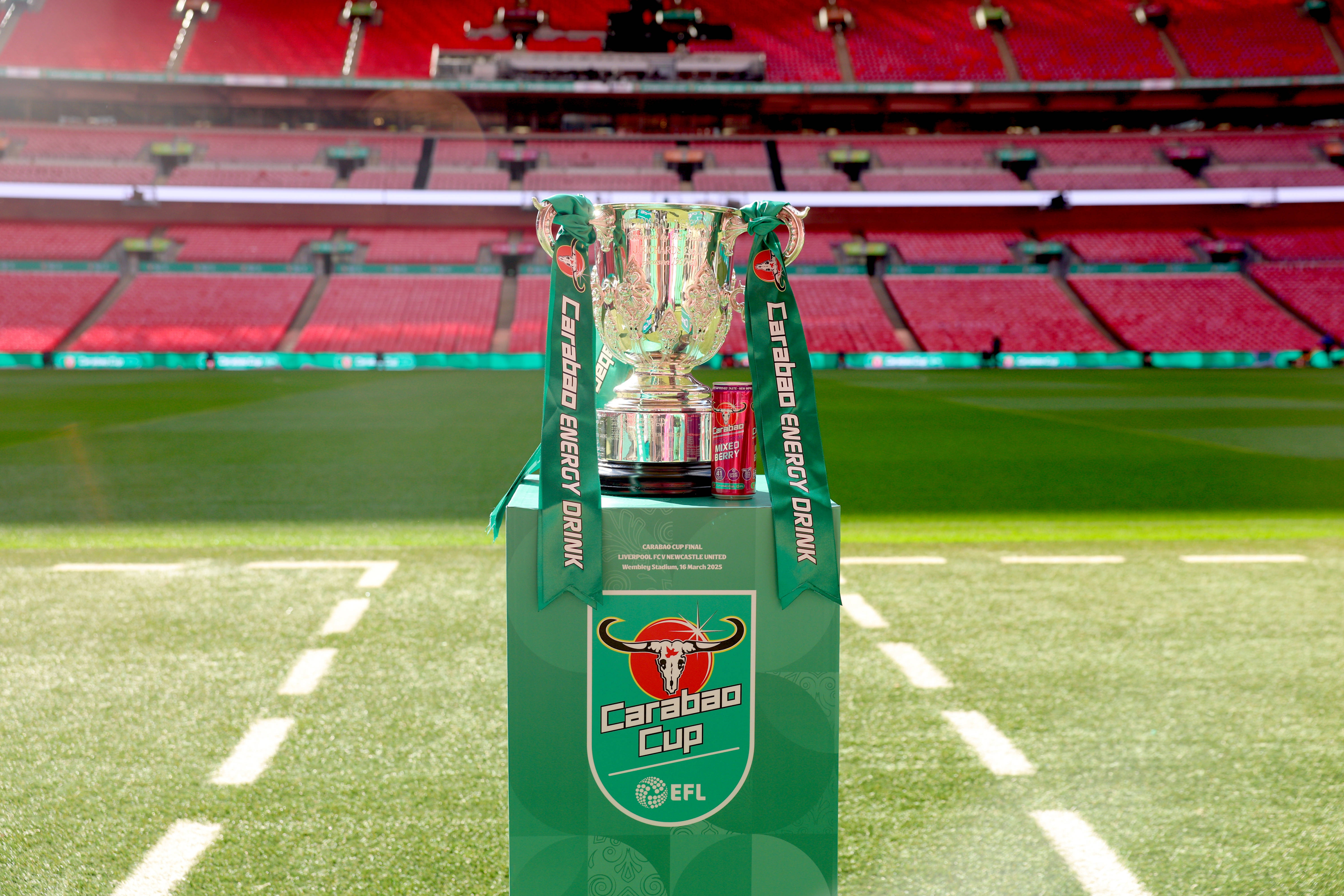 An image of the Carabao Cup trophy on a stand in the dugout at Wembley Stadium