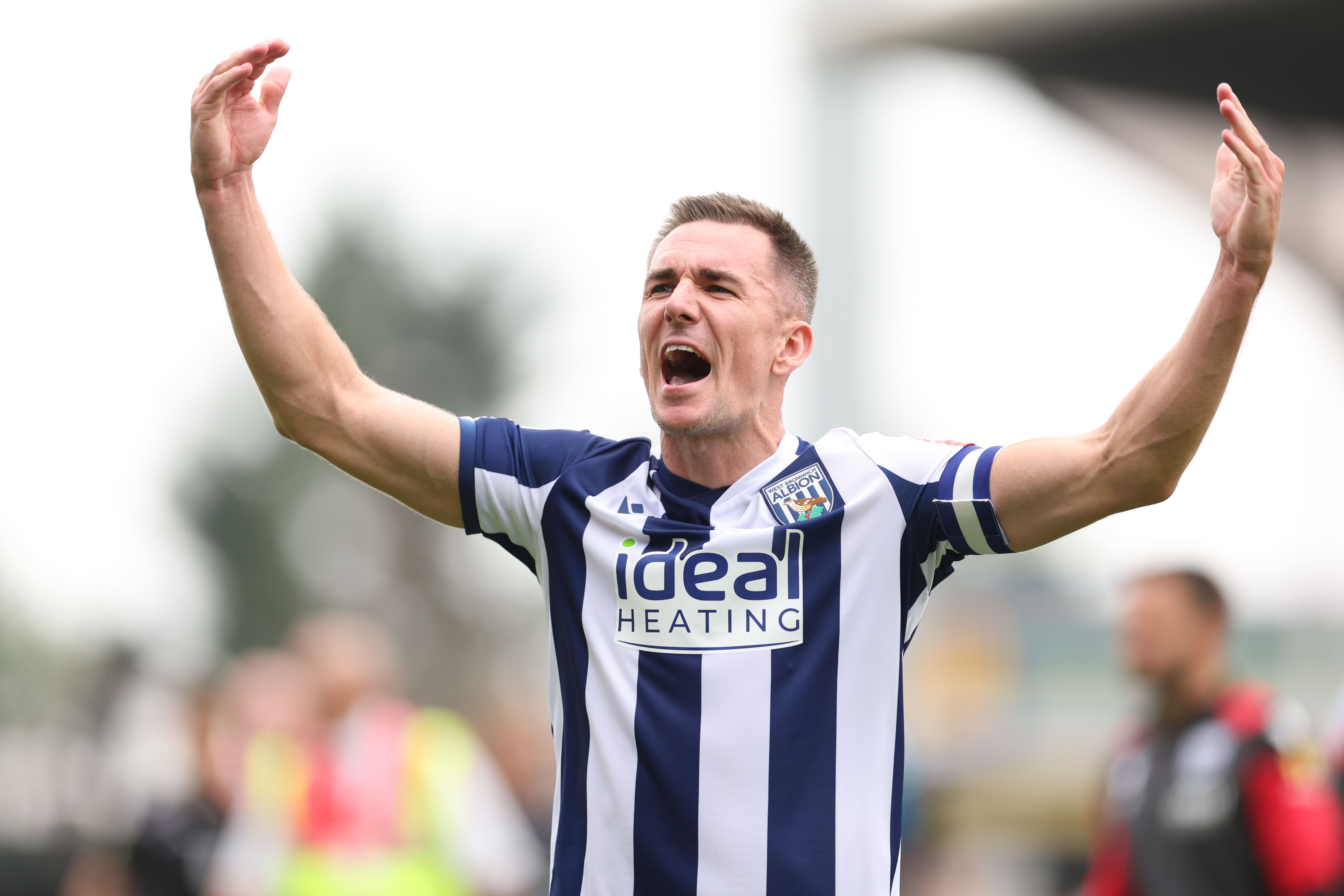Jed Wallace celebrates at full-time after WBA beat Wrexham