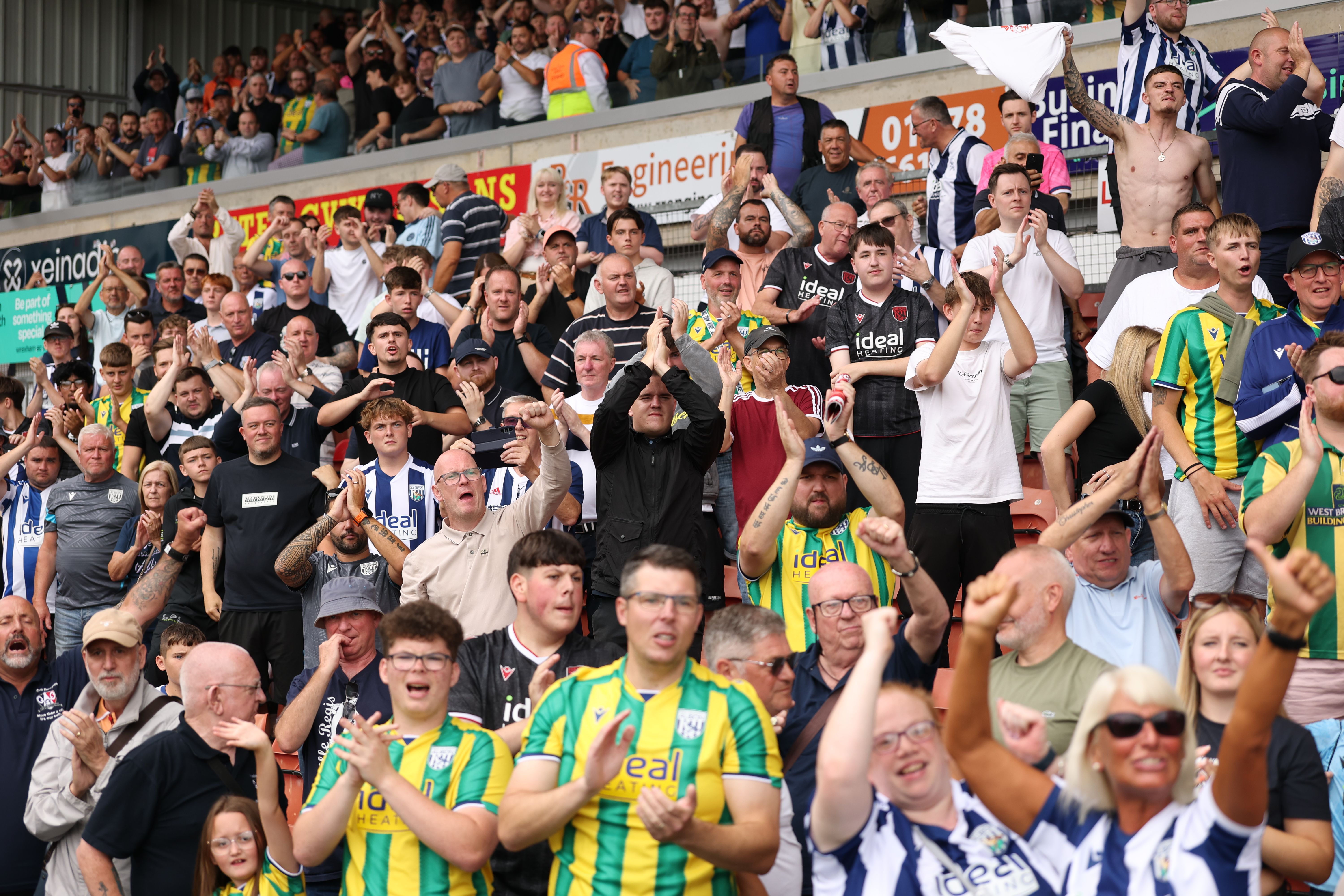 Albion fans applauding in the away end at Wrexham