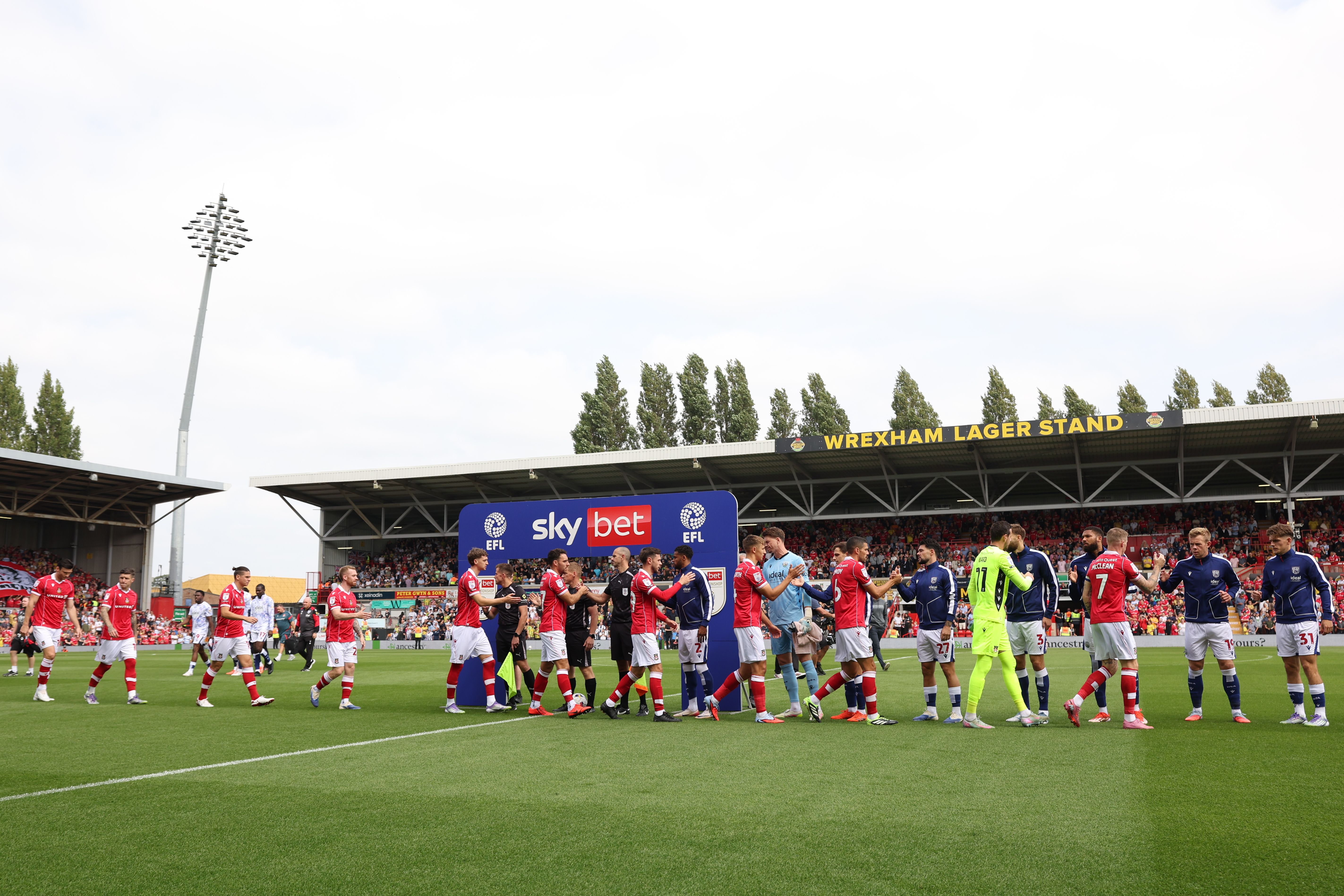 Wrexham and Albion teams shake hands before the game 
