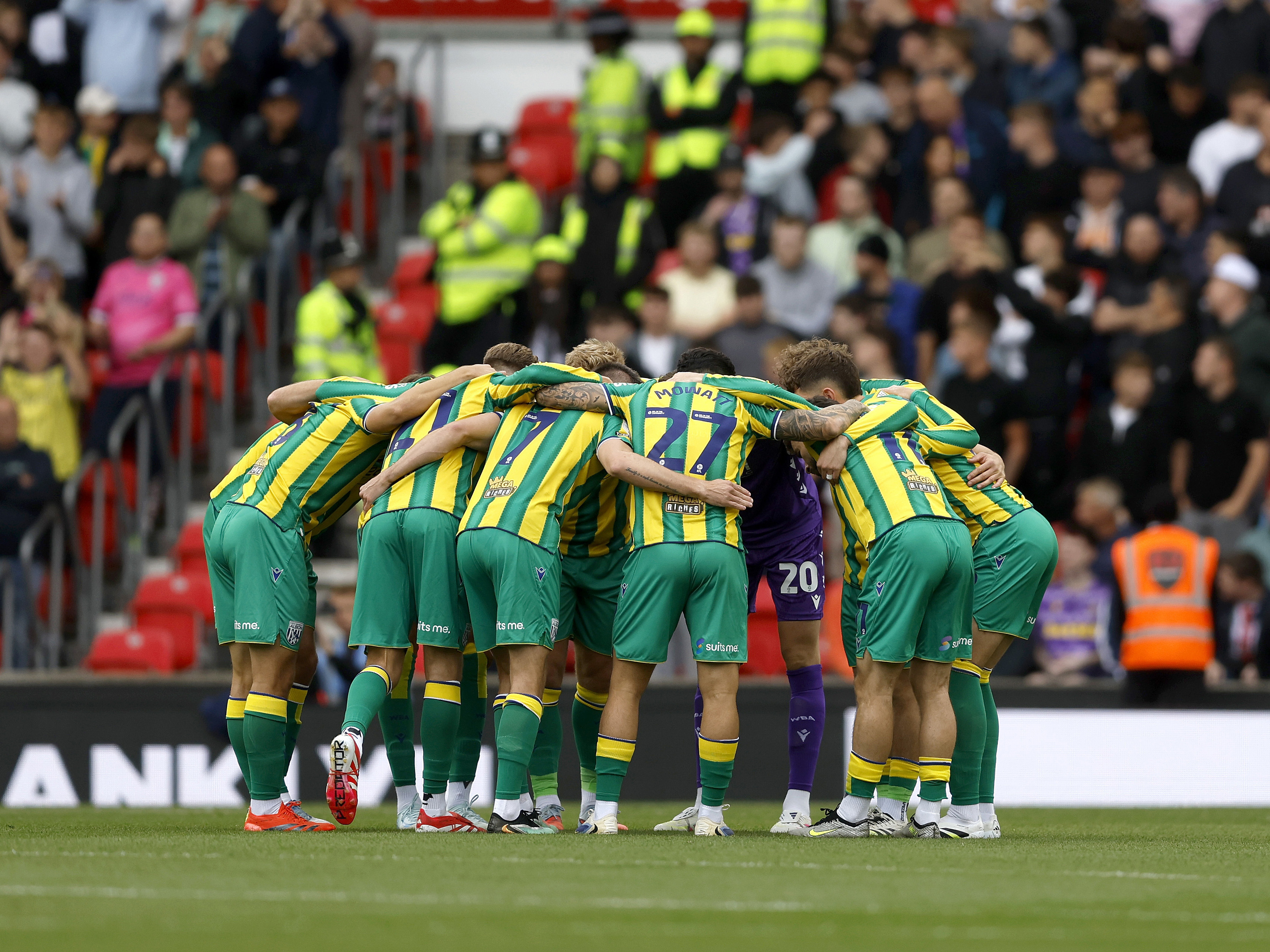 An image of Albion's team huddle pre-match at Stoke