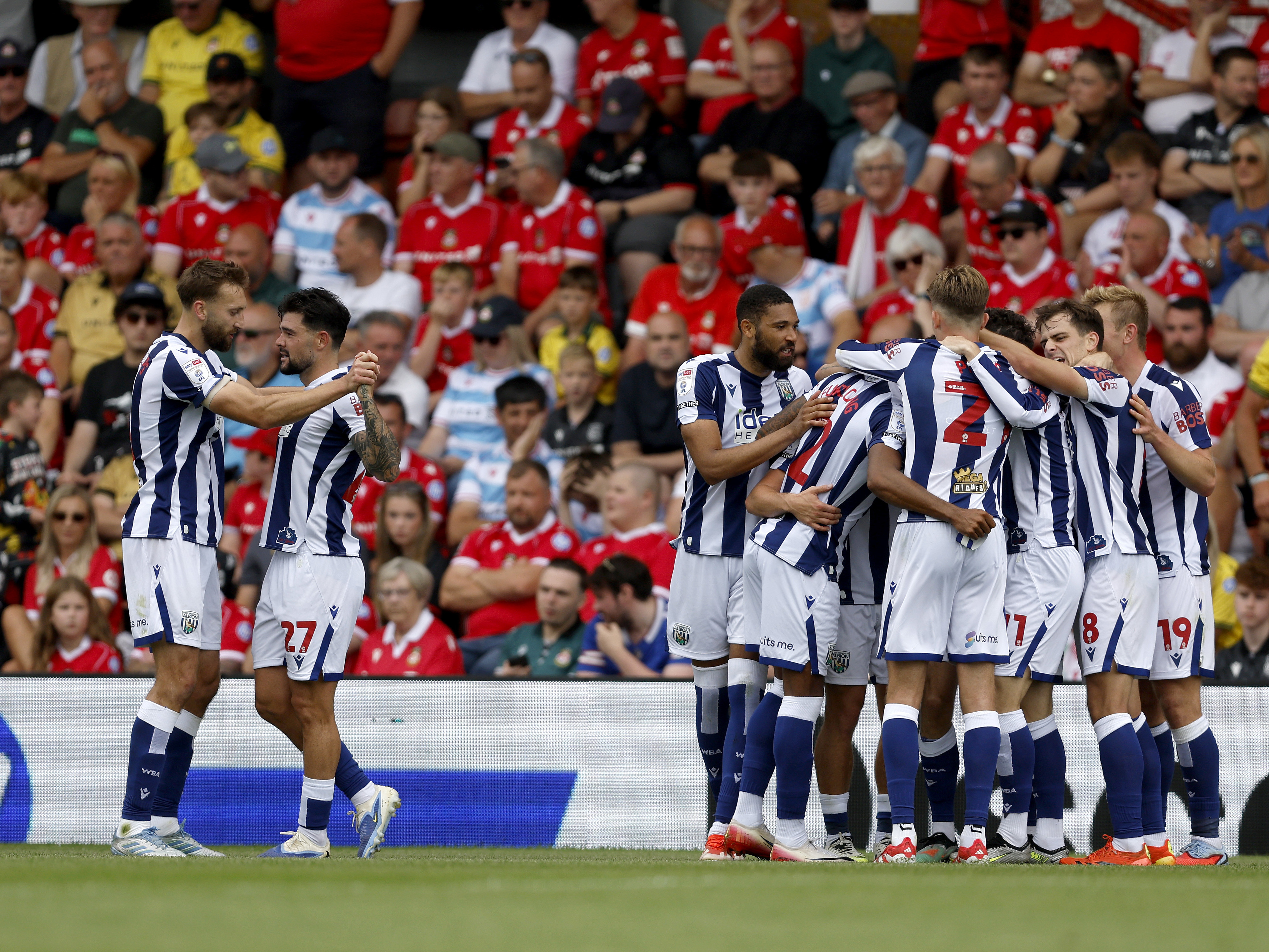An image of Albion celebrating Wallace's goal against Wrexham
