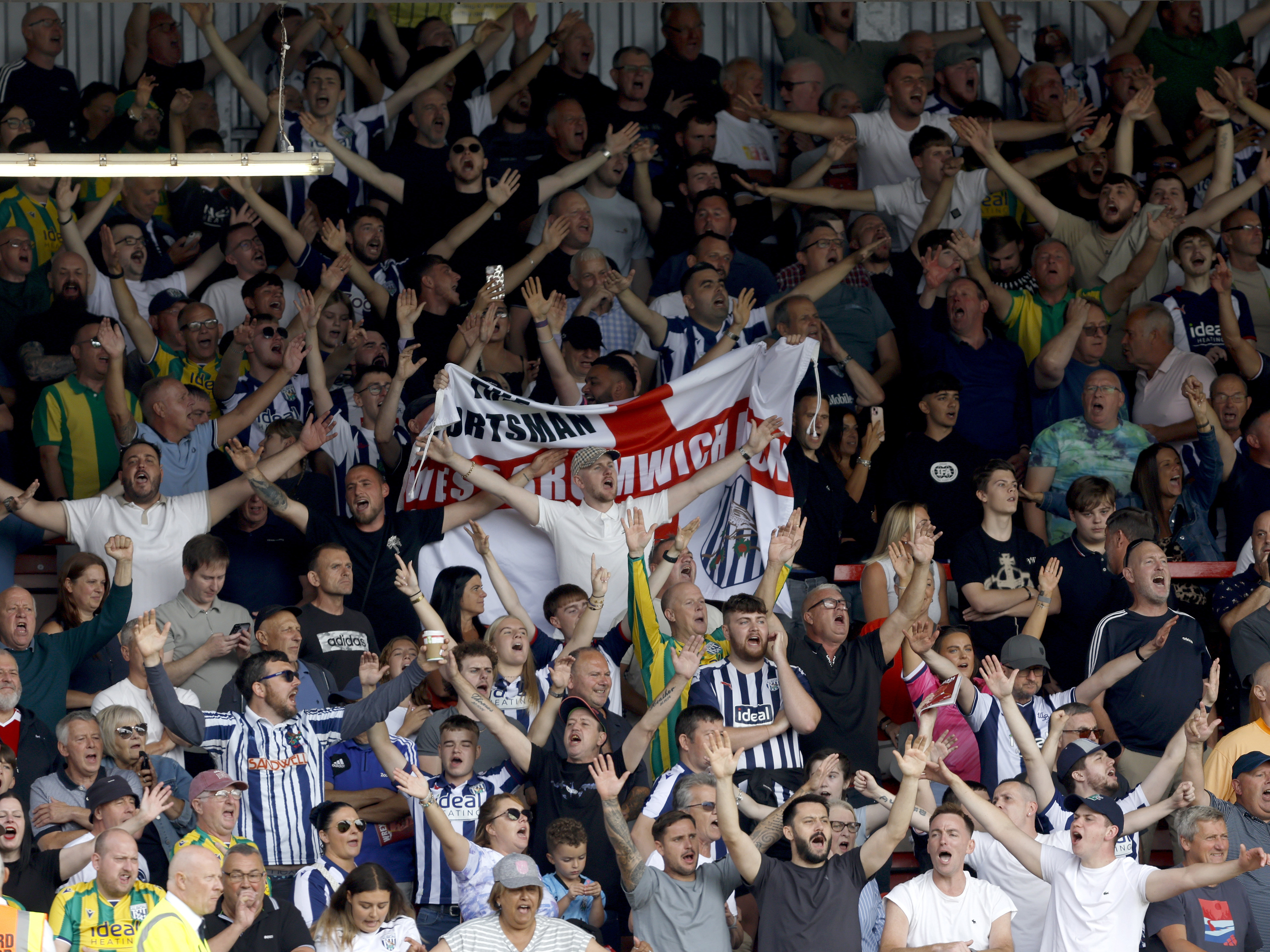 An image of Albion supporters cheering on their team at Wrexham