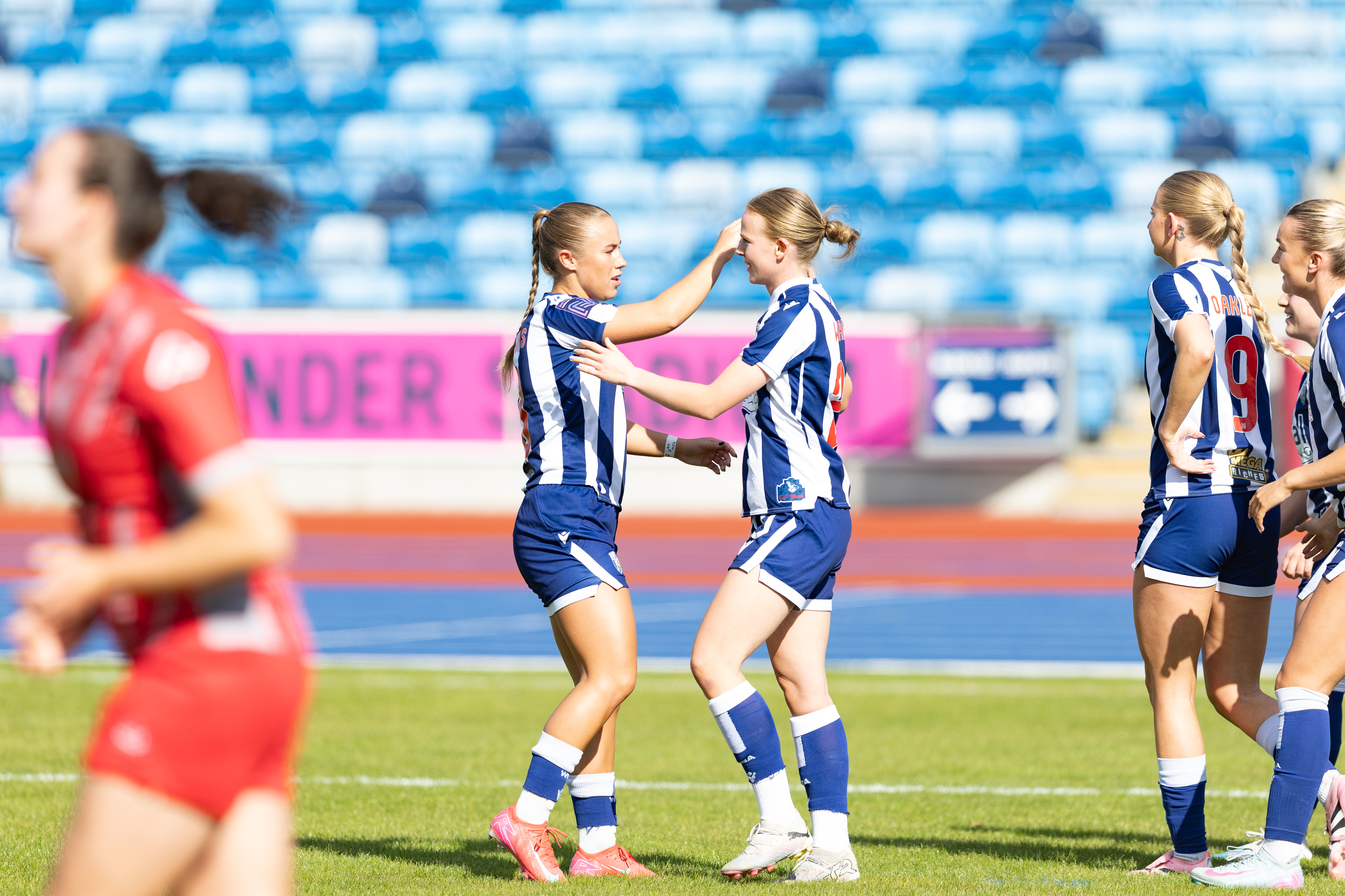 Phoebe Warner high-fives Seren Watkins.