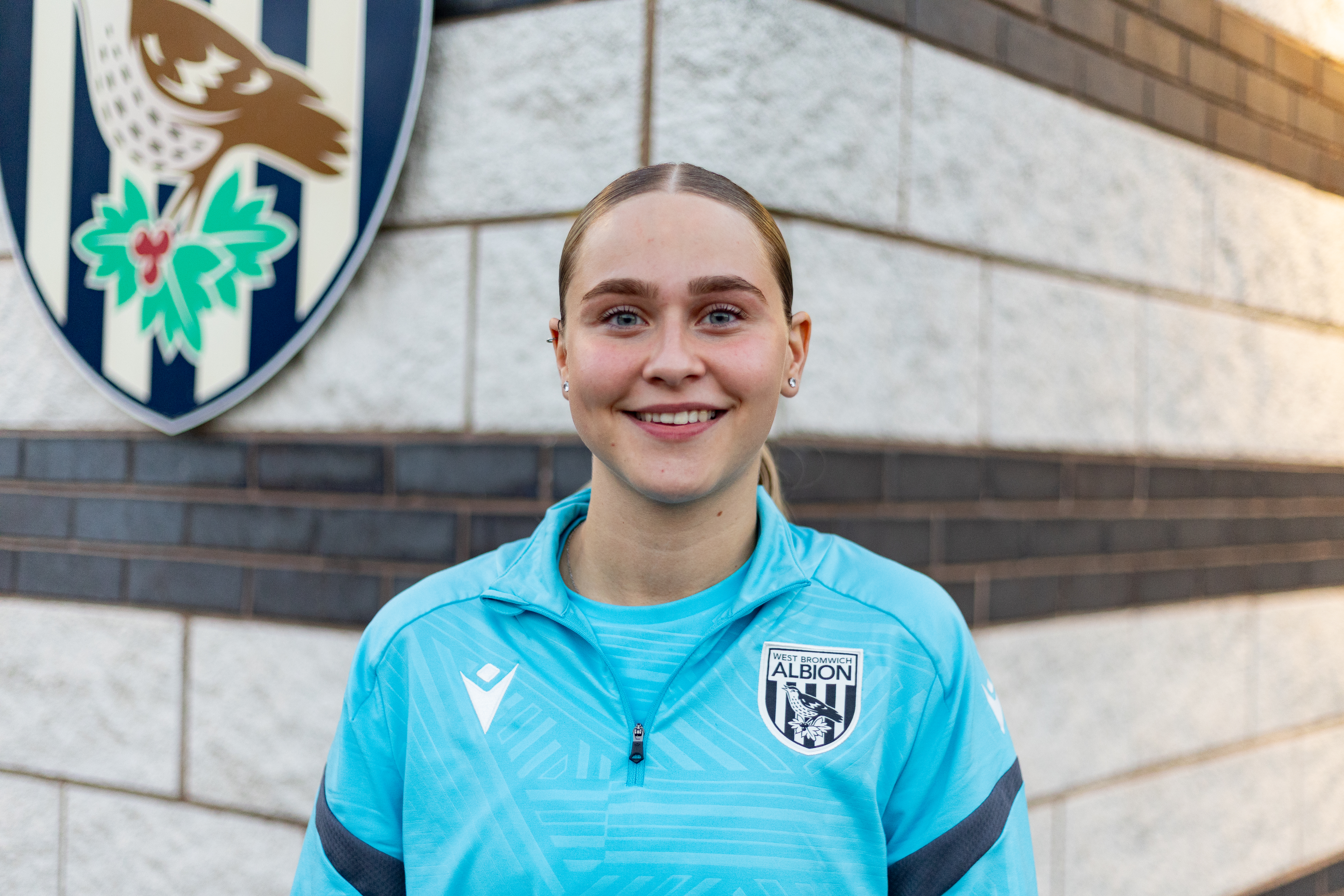 Mia Sorrentino smiling at the camera while wearing Albion gear