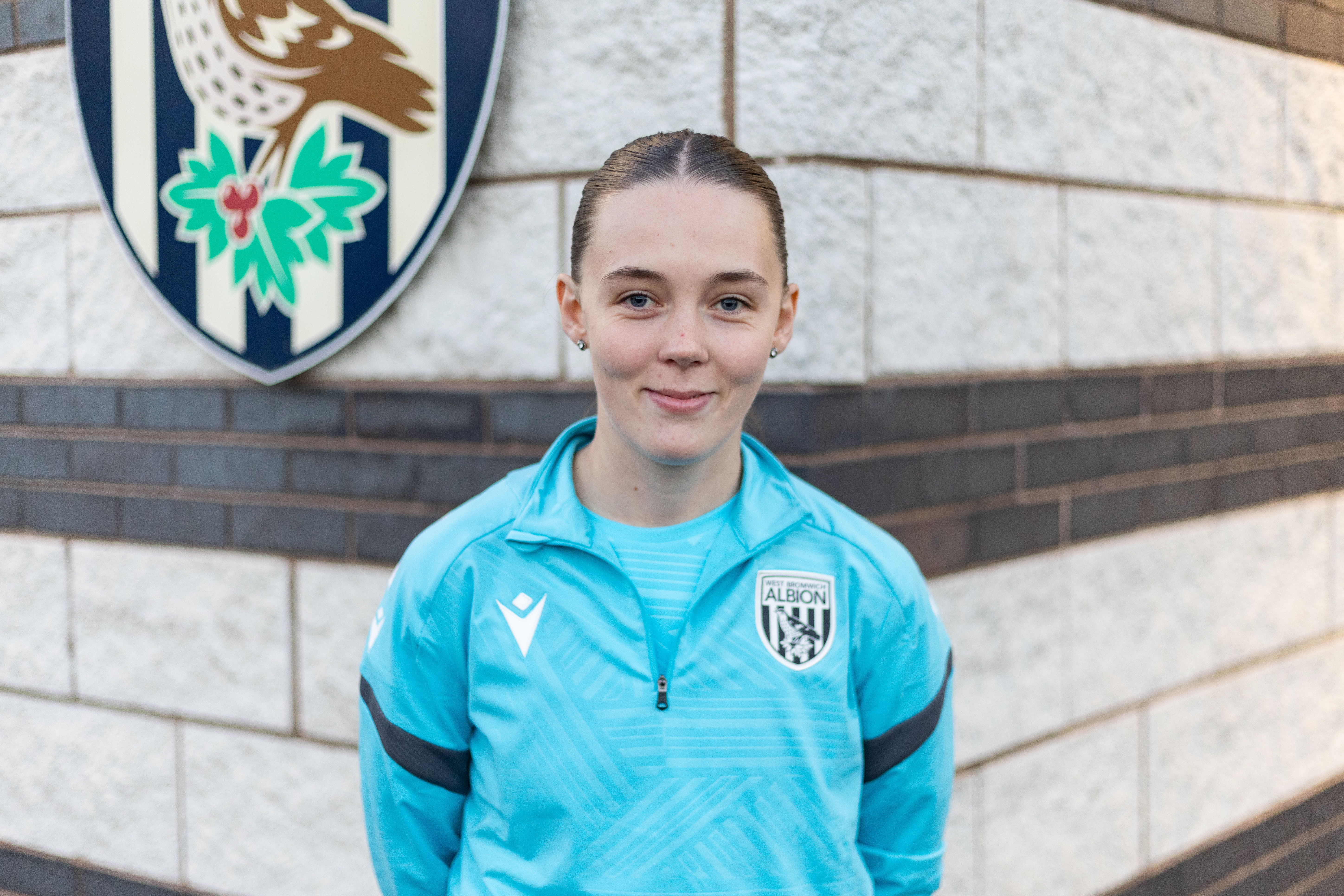 Millie Pullen smiling at the camera in WBA gear