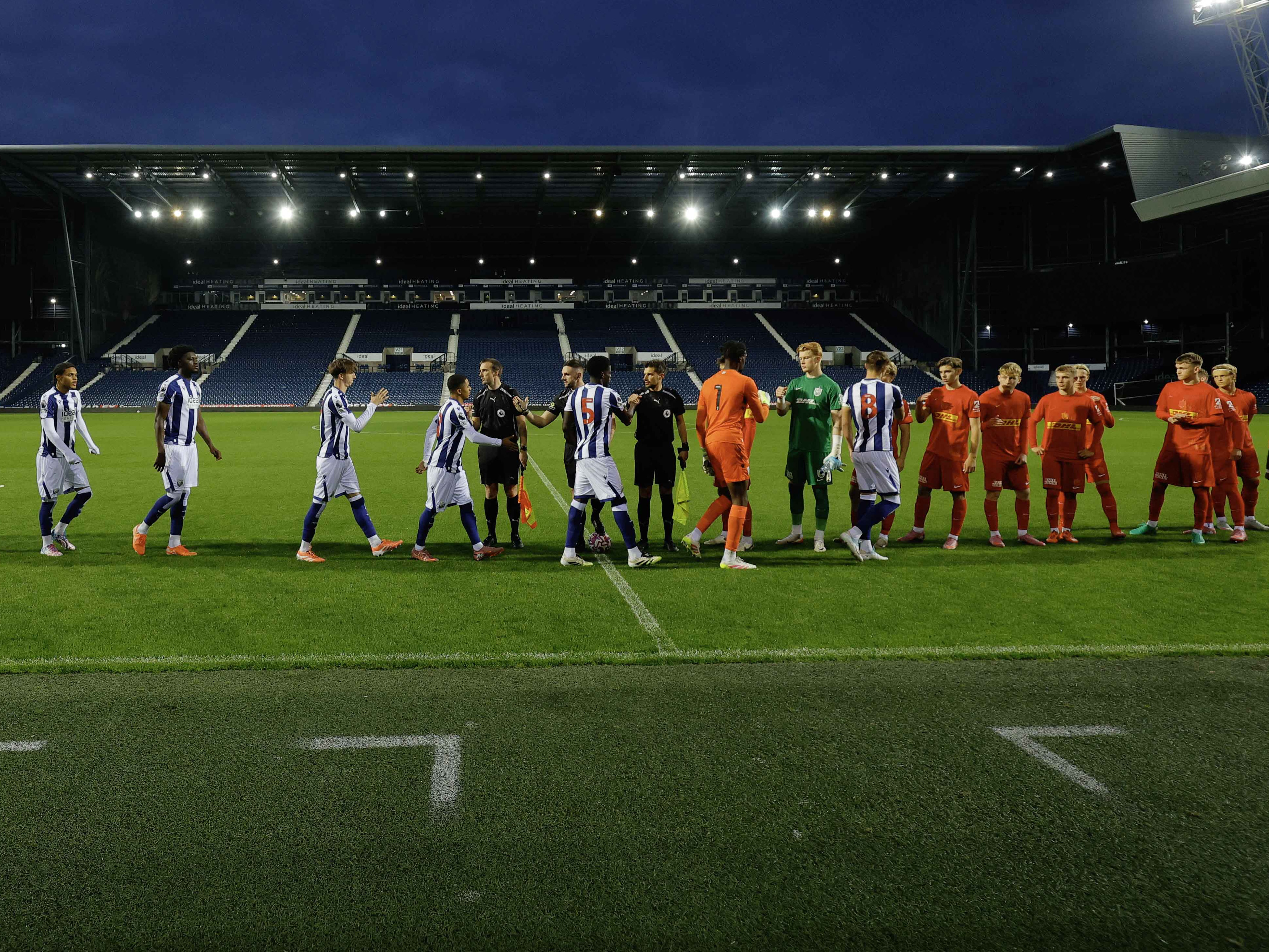 Albion and FC Nordsjælland players line up and shake hands before their match at The Hawthorns
