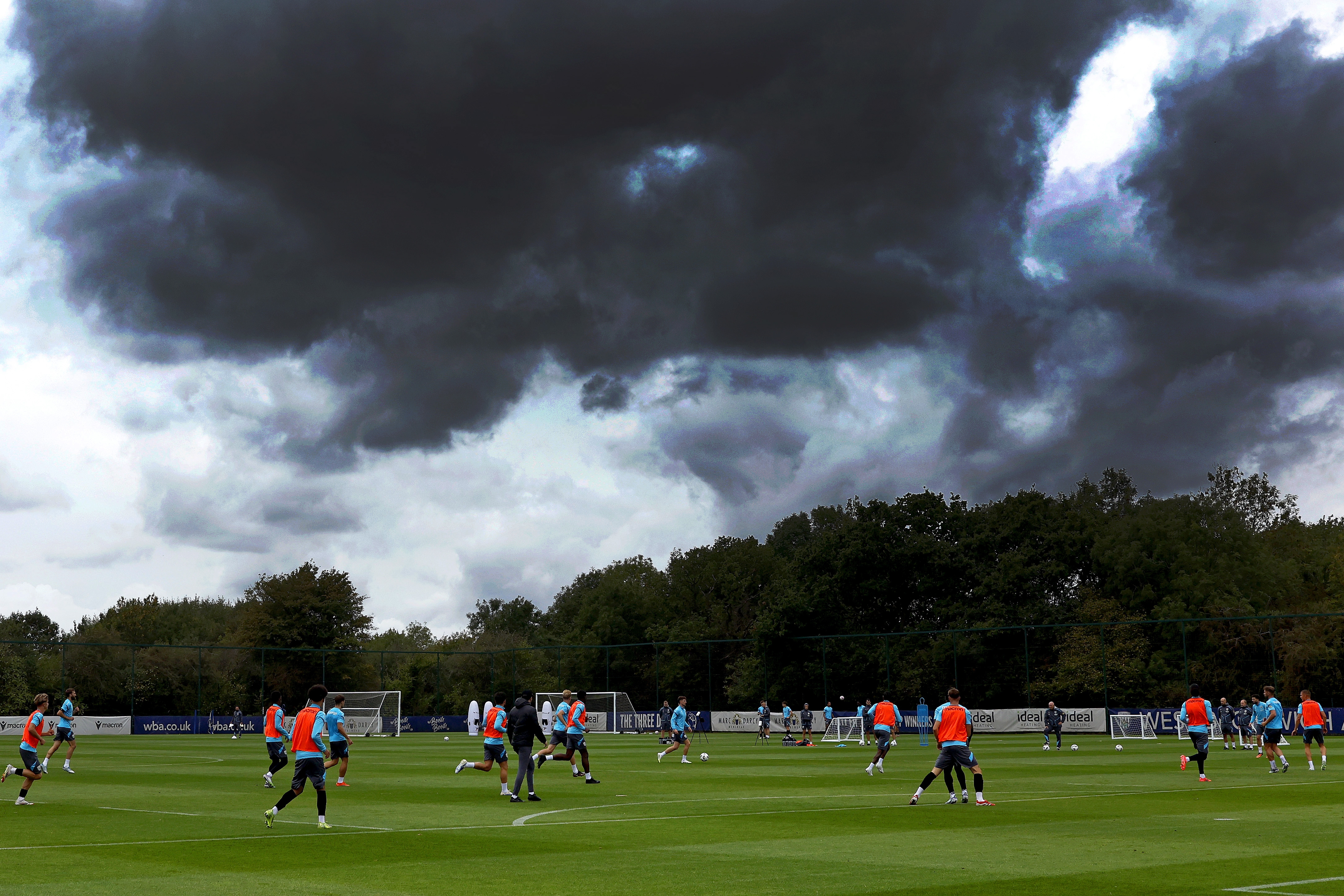 A general shot of training with plenty of players in shot and stormy skies above