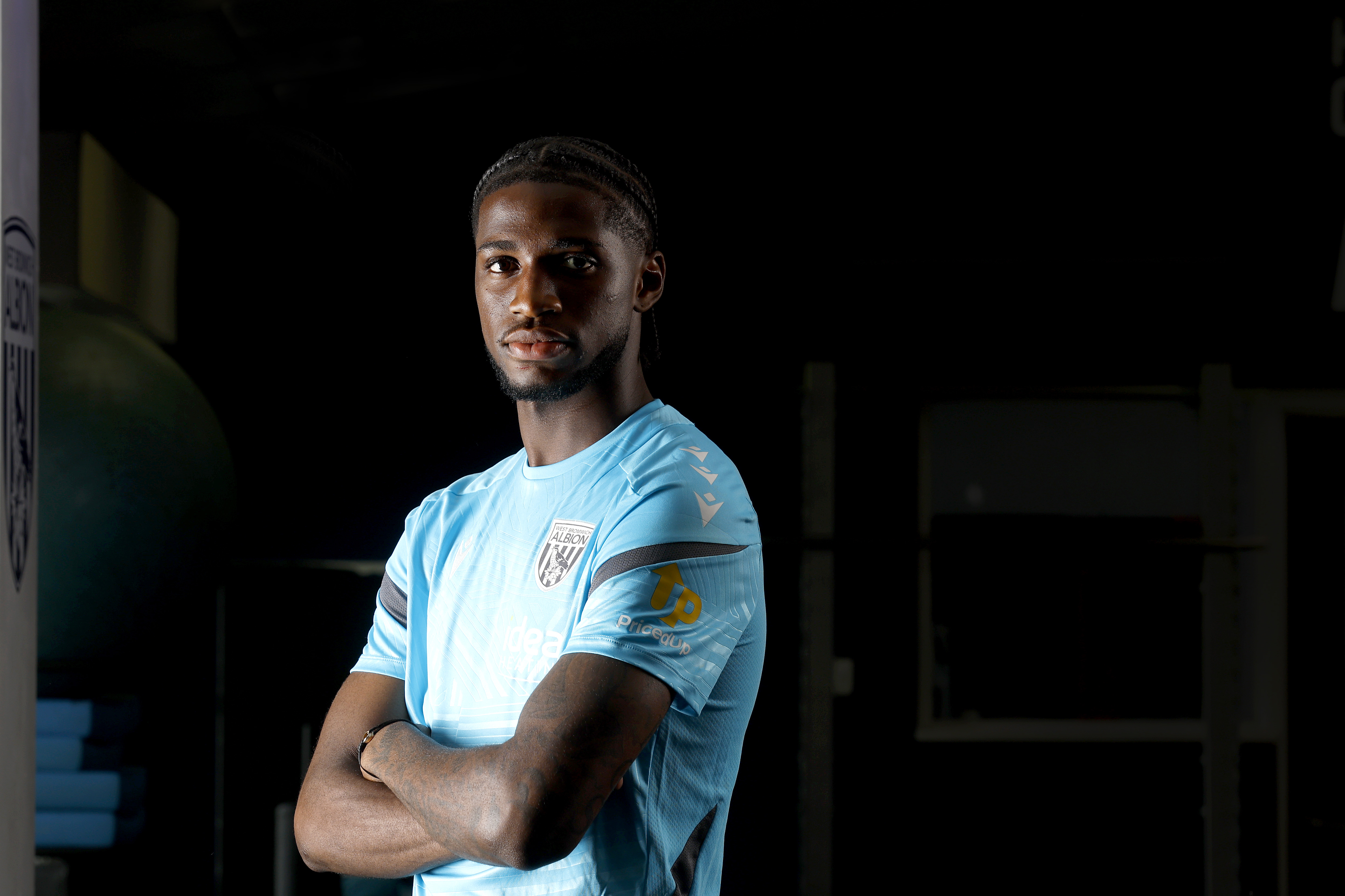 Samuel Iling-Junior looking at the camera with his arms crossed