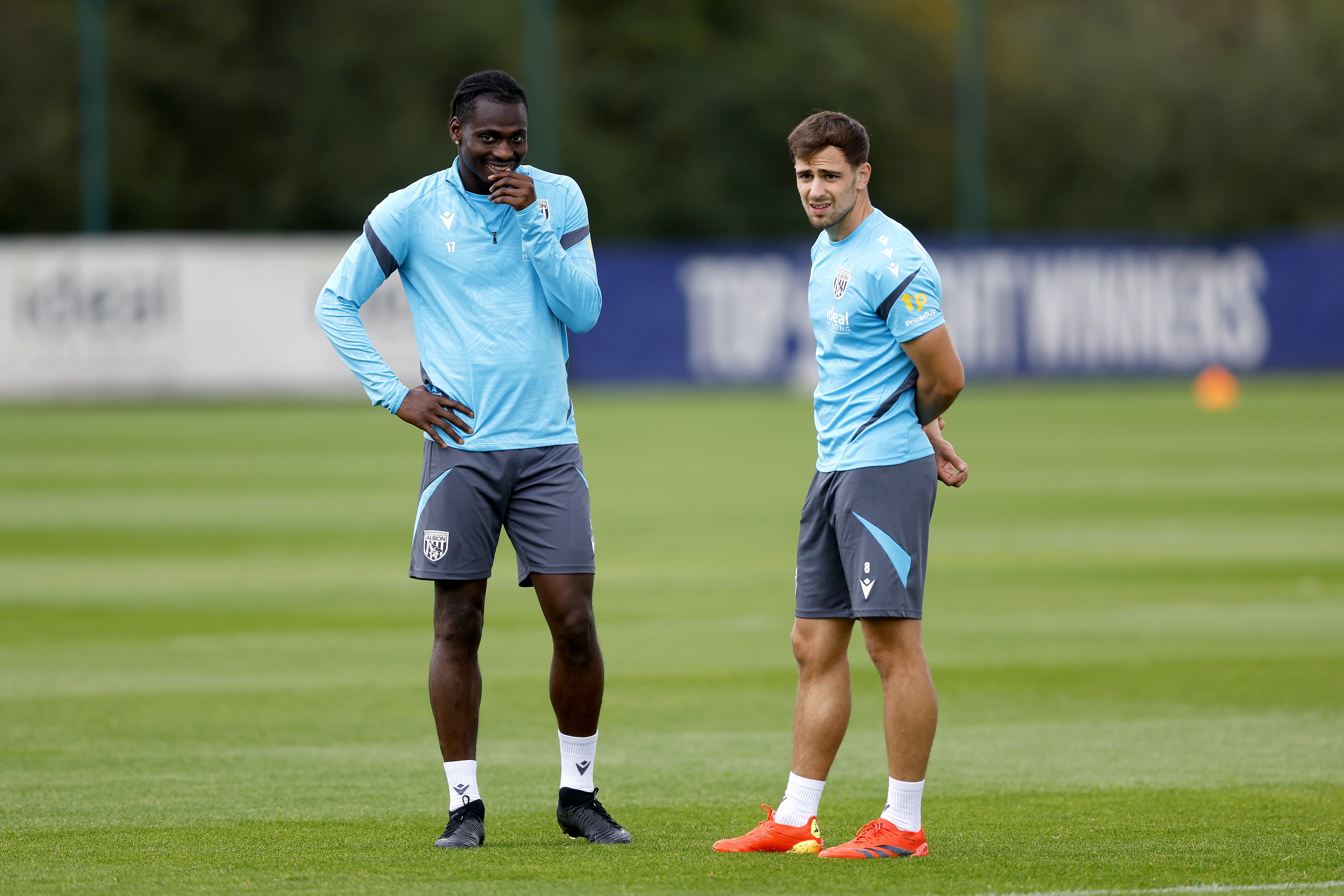 Jayson Molumby and Ousmane Diakité talking during training 