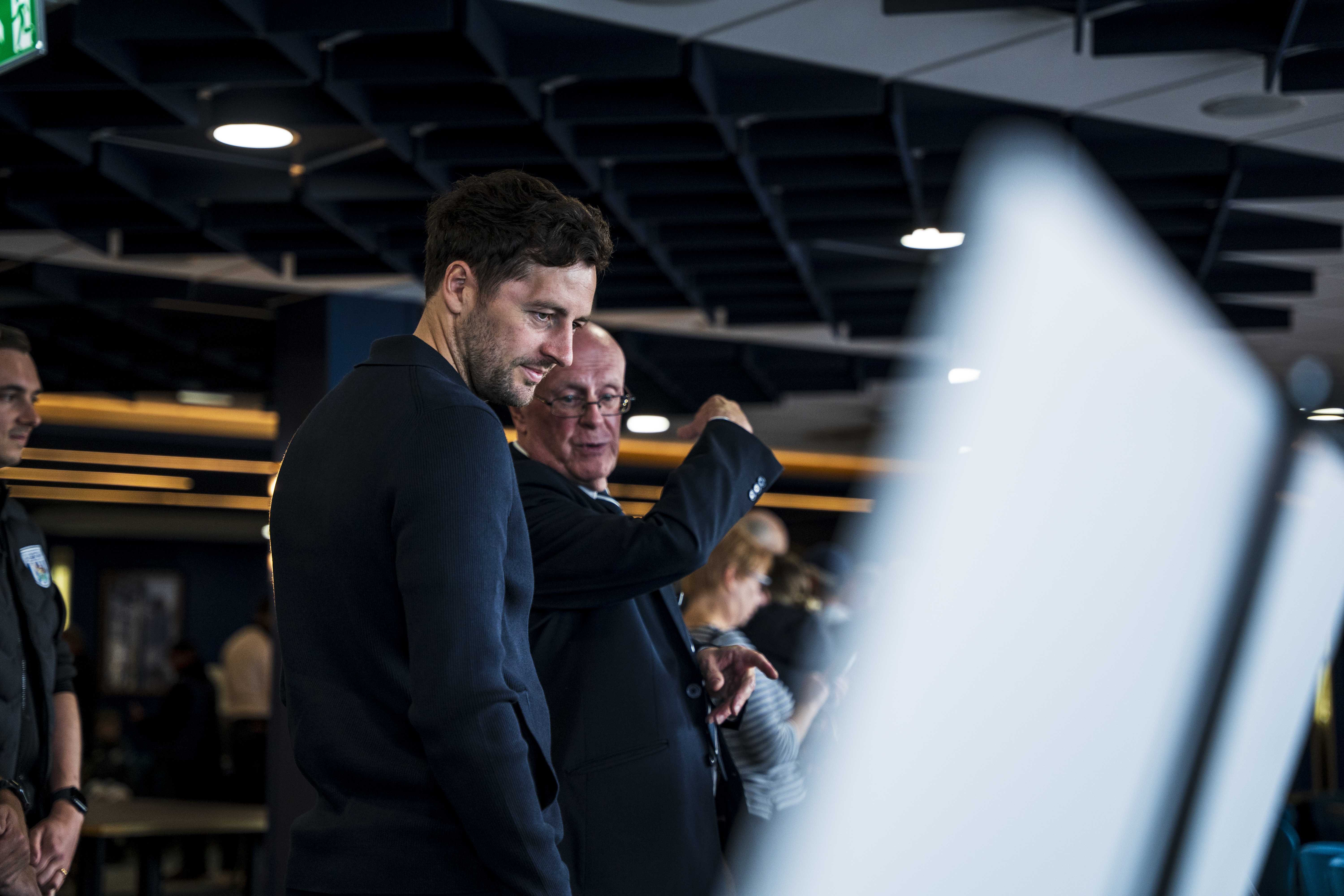 Ryan Mason looking at all the memorabilia and a specially curated gallery of 125 iconic Hawthorns images