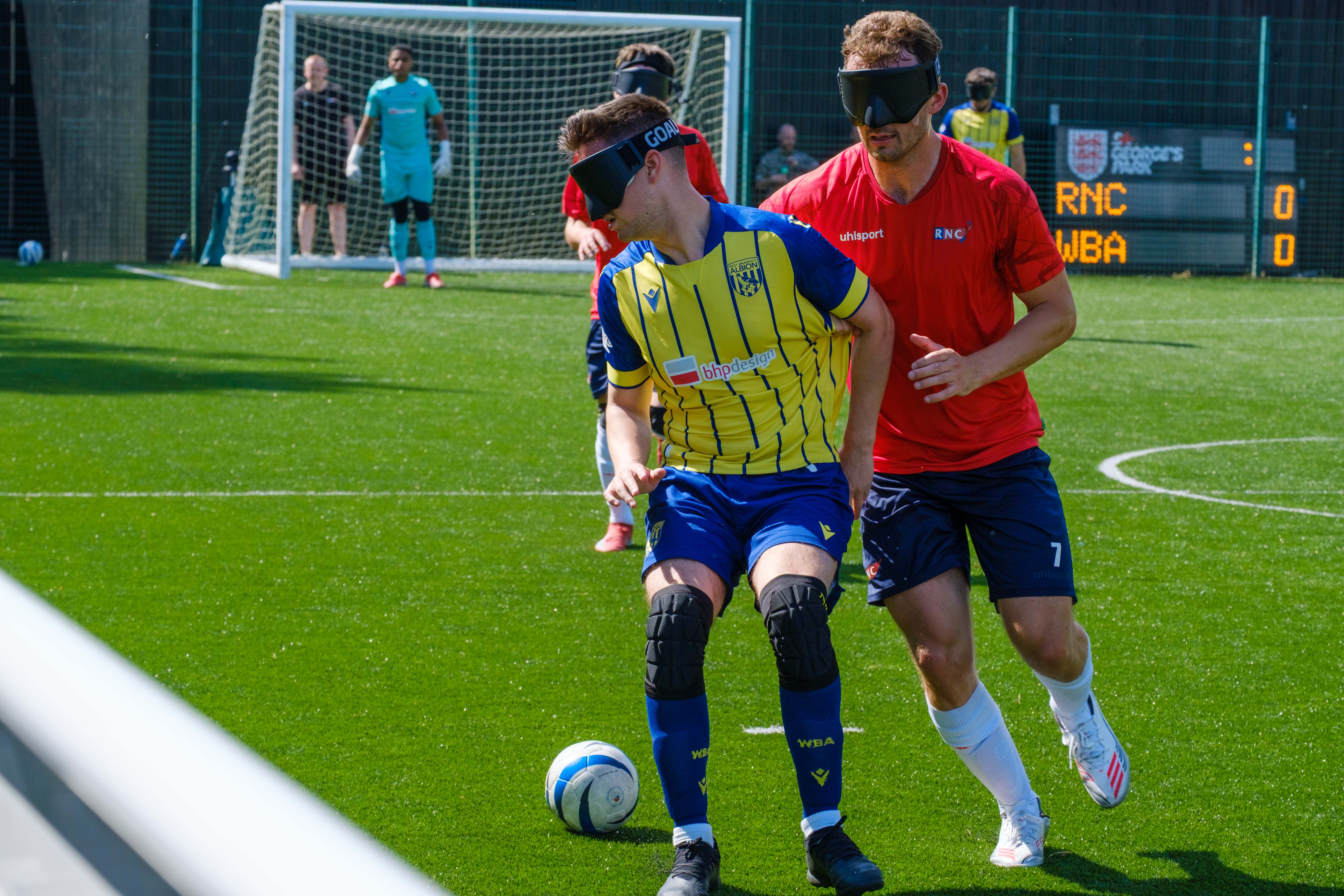 Toby Addison shields the ball from an RNC player.