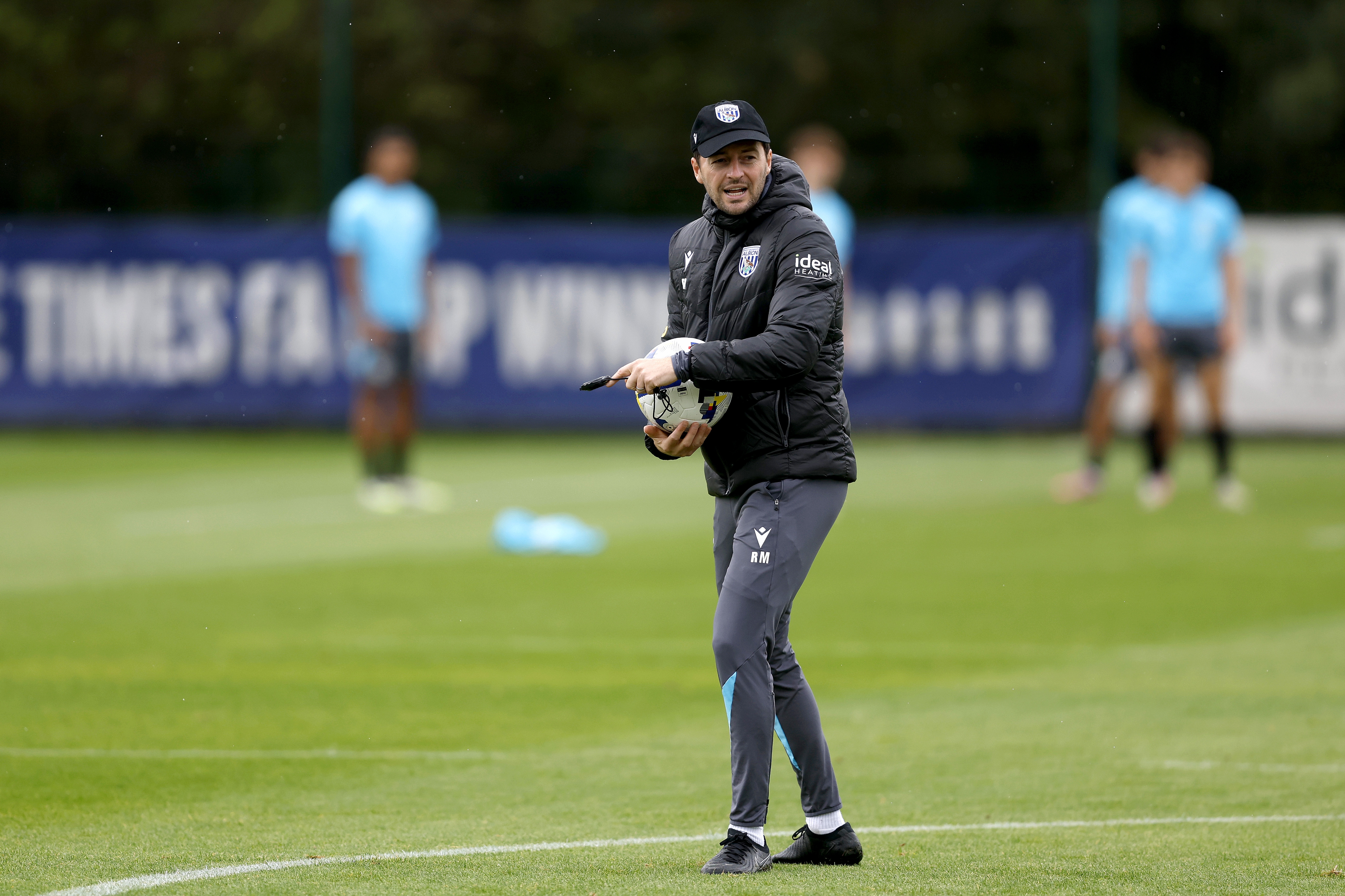 Ryan Mason delivering instructions to players on the training pitch 