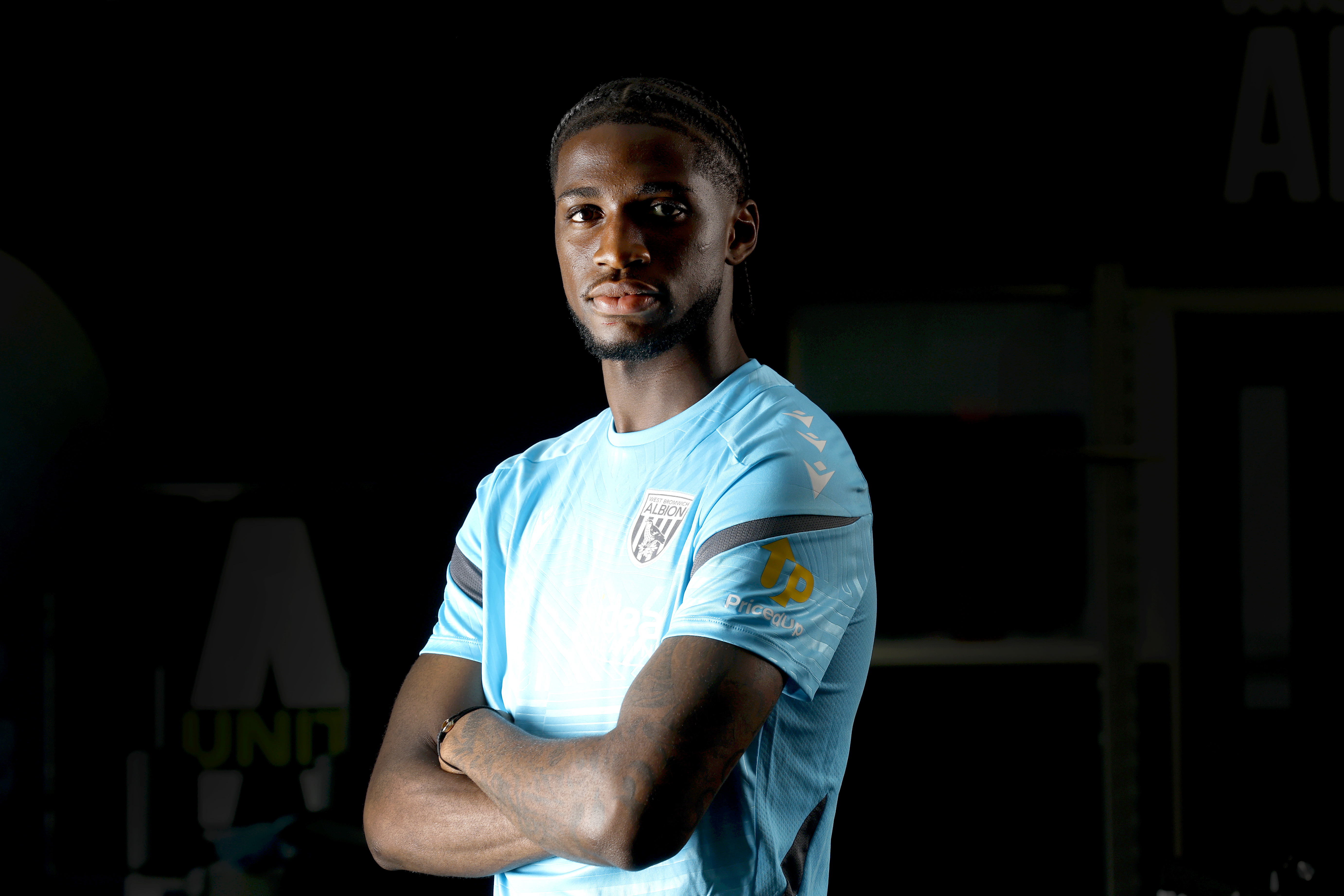 Samuel Iling-Junior looking at the camera with his arms crossed