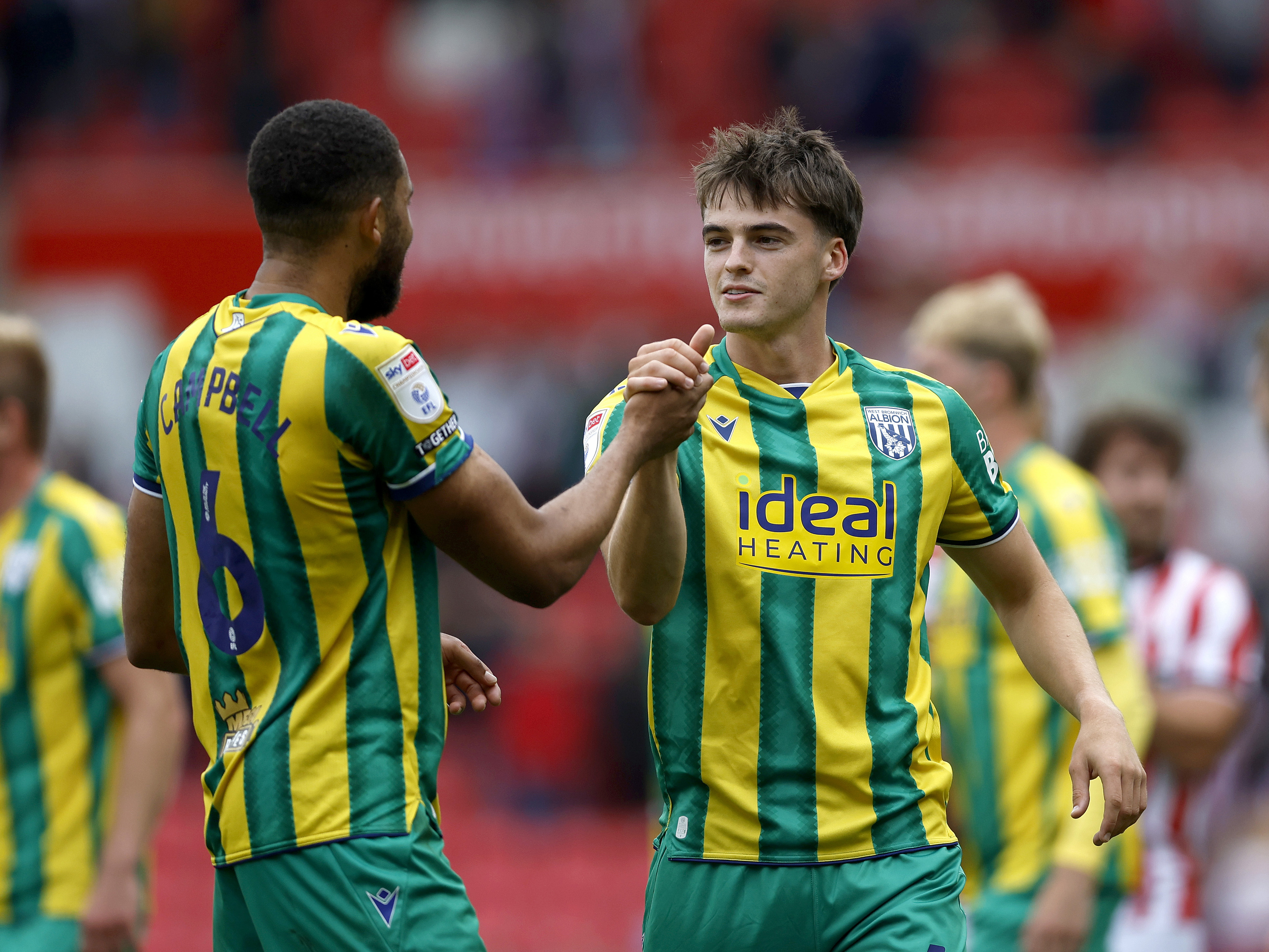 An image of Alex Williams and George Campbell embracing after Albion's win at Stoke