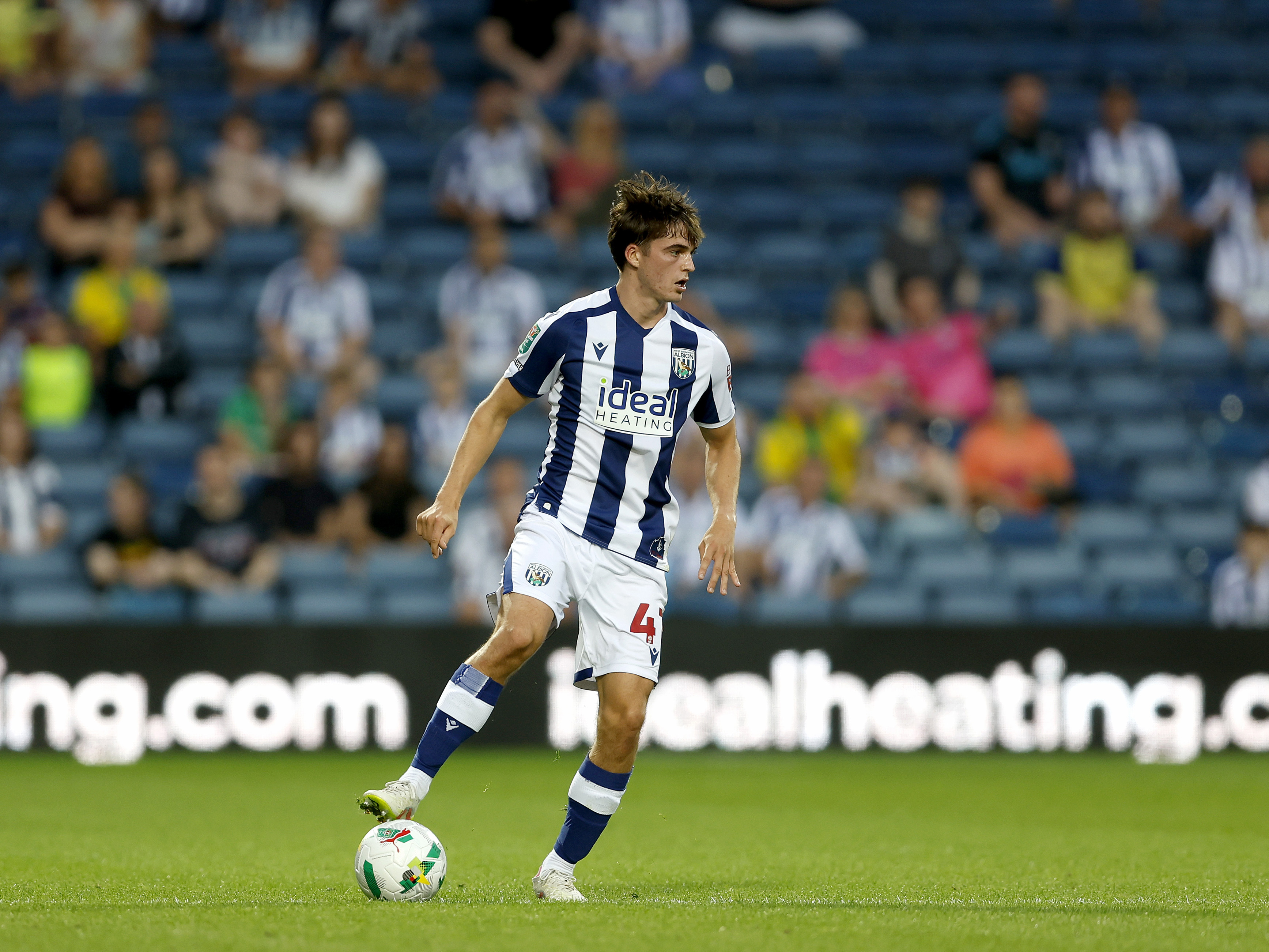 Alex Williams on the ball during a game in the home kit 