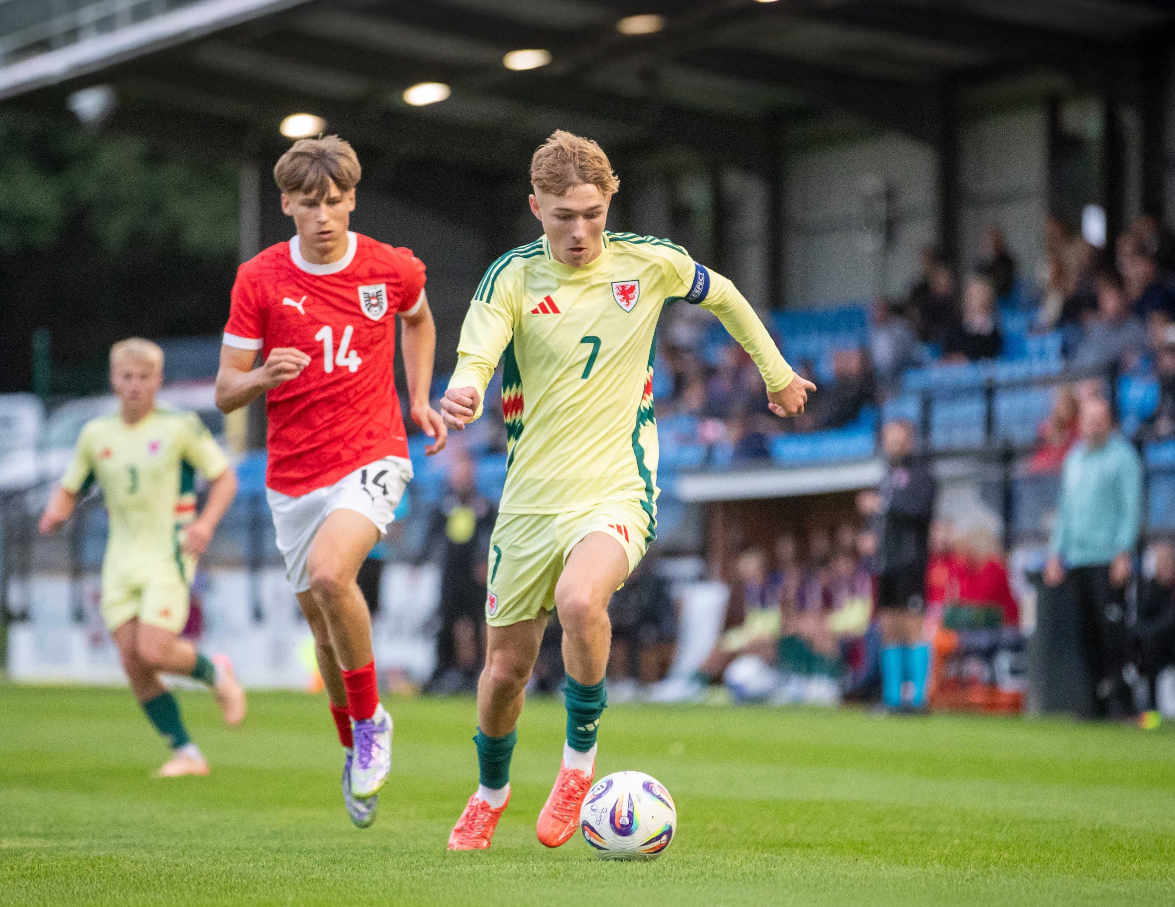 A photo of Albion youngster Ollie Bostock in the Wales yellow away kit
