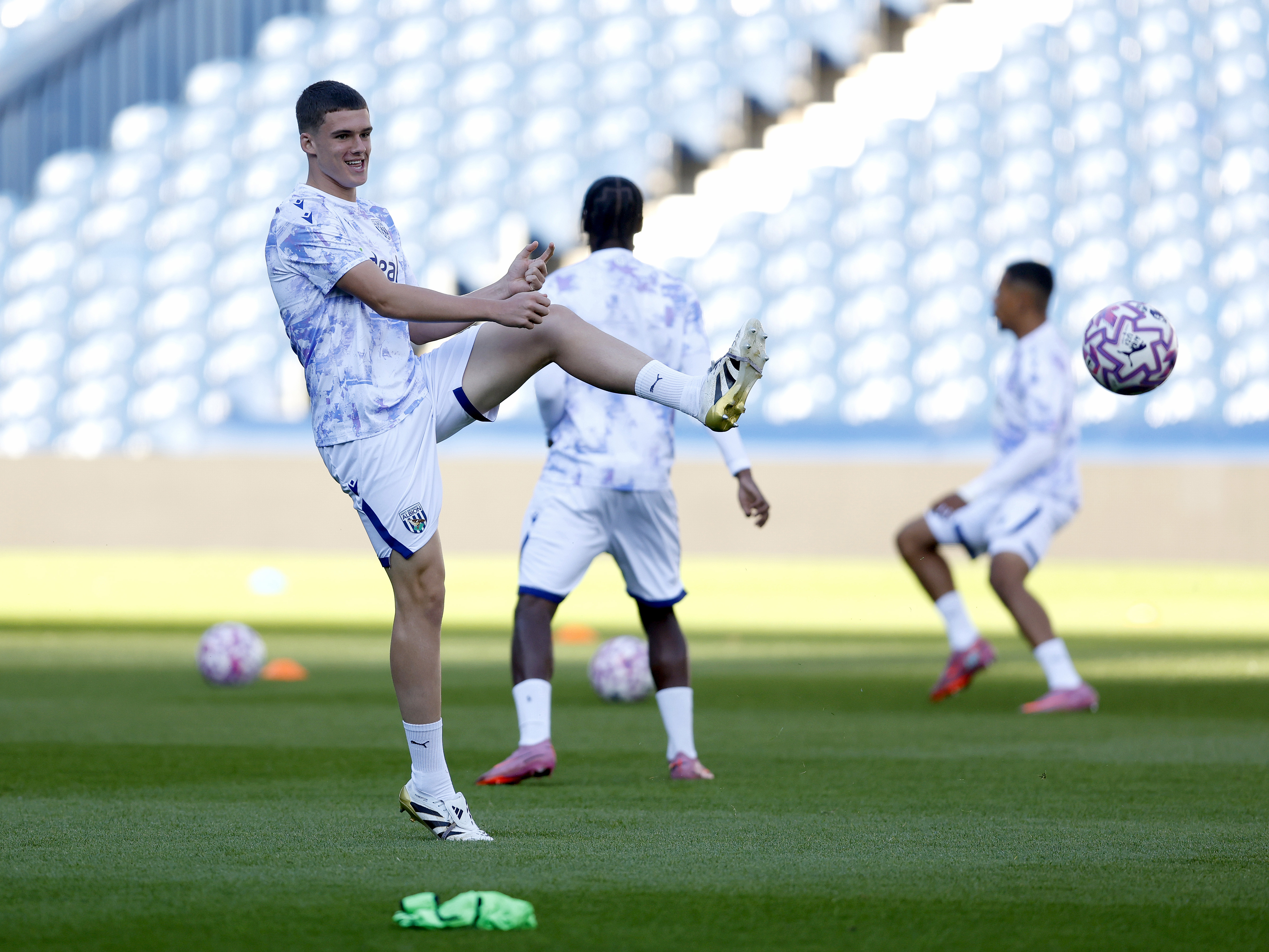 A photo of U21 midfielder Matt Crowther warming up at The Hawthorns