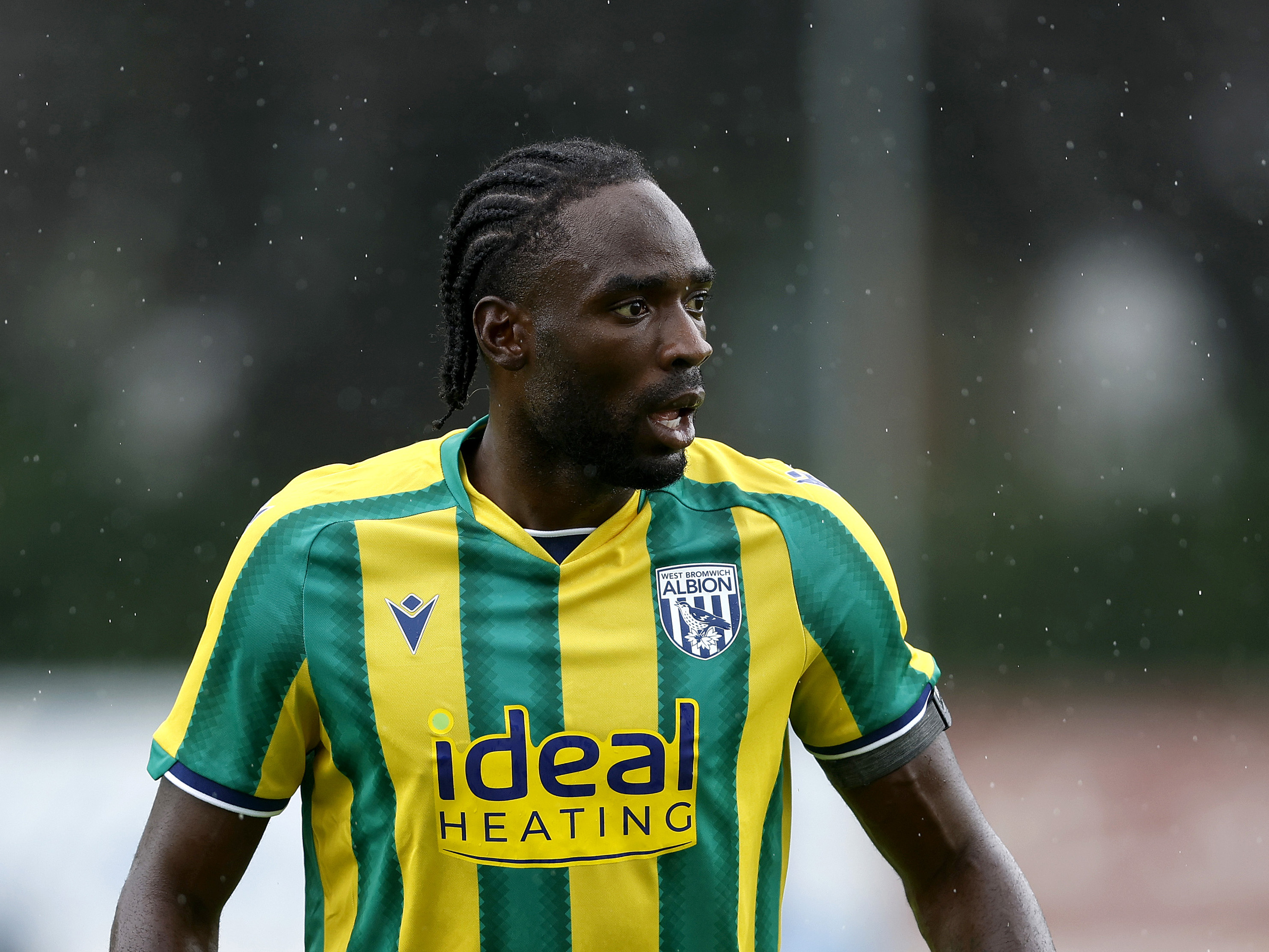 Devante Cole in action in the yellow and green away kit 
