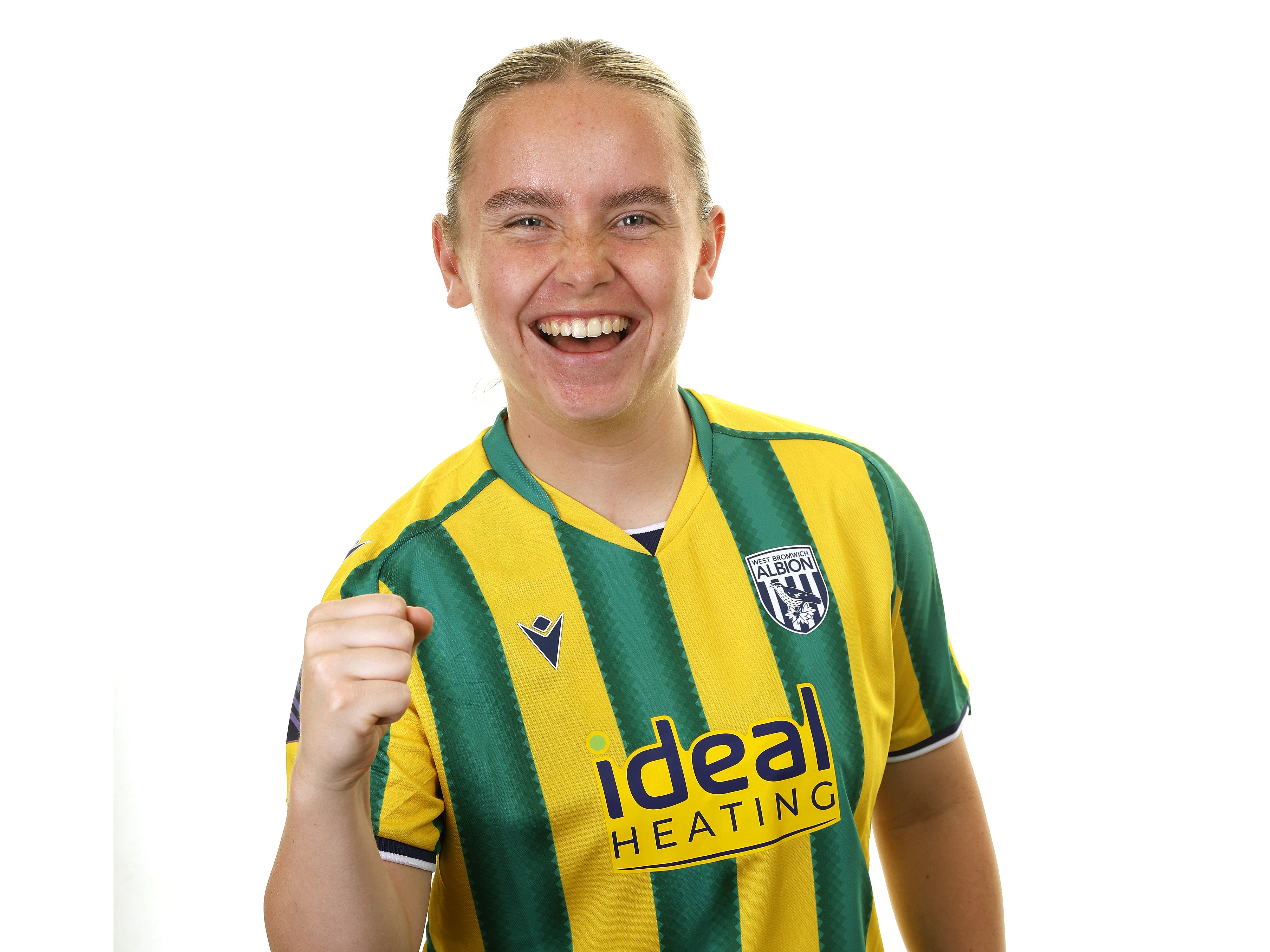 Ella Haughey smiling at the camera while wearing a yellow and green kit 